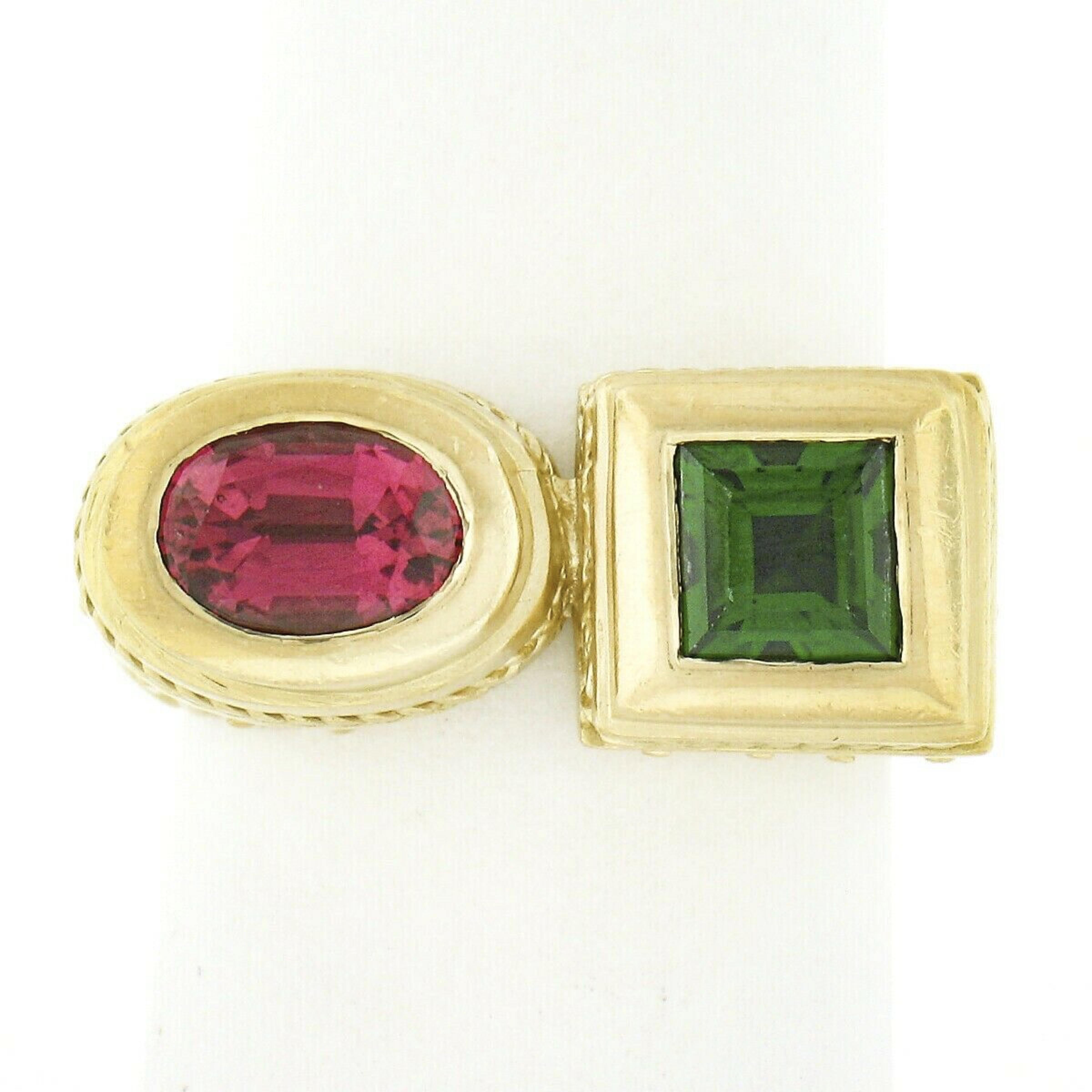 Here we have a beautifully detailed ring that is designed by SeidenGang and crafted from solid 18k yellow gold. This two stone ring features a very fine pink tourmaline and green tsavorite in which are each neatly bezel set at the raised top. The