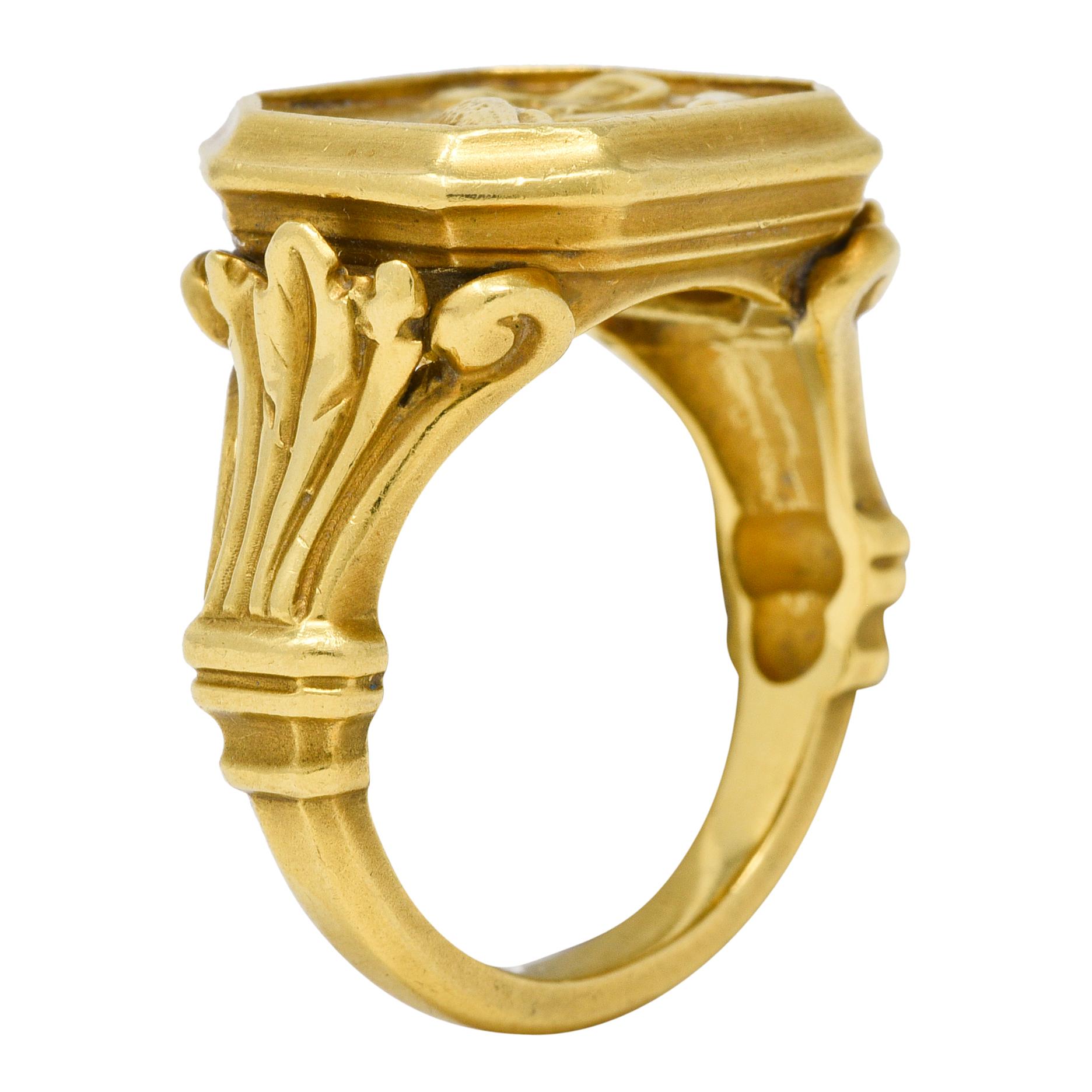 Designed as a signet ring with an octagonal shaped face centering a cameo
Depicting the Greek god Hermes wearing a helmet and feeding a bird
With a raised grooved surround and flanked by plume shoulders
Split with scroll motif and engraved