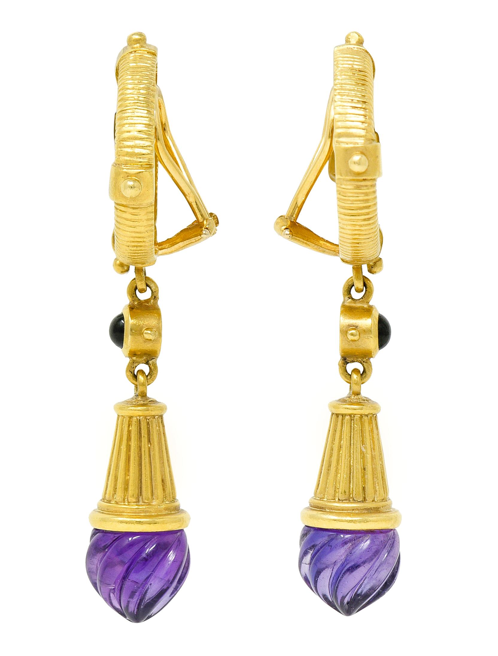 Ear-clip earrings feature a cameo of the Greek figures Pegasus and Bellerophon - with a ridged surround

Suspending articulated drops as deeply grooved gold speculum forms terminating with amethysts

Spiral carved and transparent purple in color