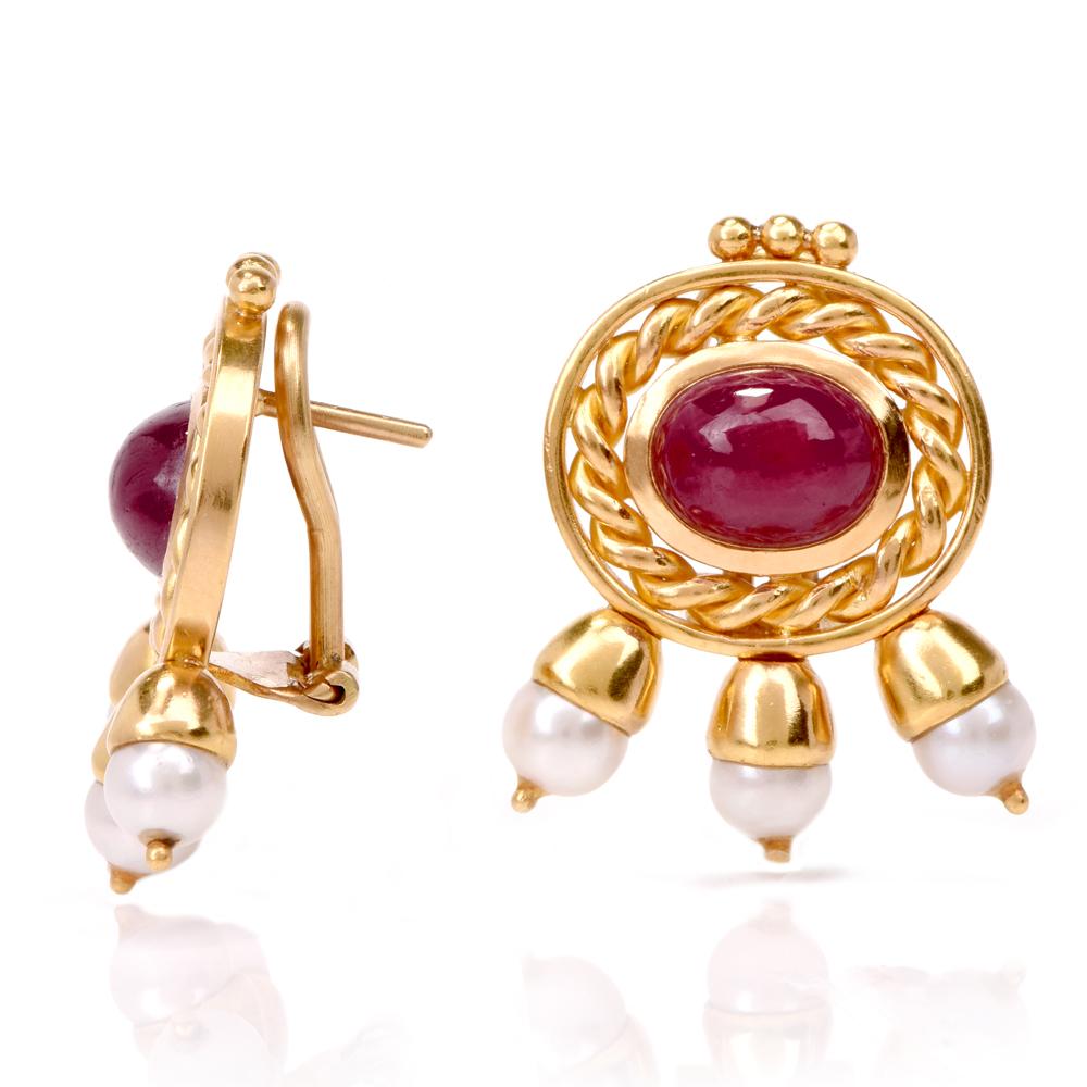 These Seidengang ruby and pearl clip  earrings are crafted in 18K yellow gold. Featuring 2 cabochon bezel set rubies approx. 4.50ct surrounded by a frame of twisted rope gold. With 6 bell-like cultured pearls 5mm in diameter underneath. Weighing
