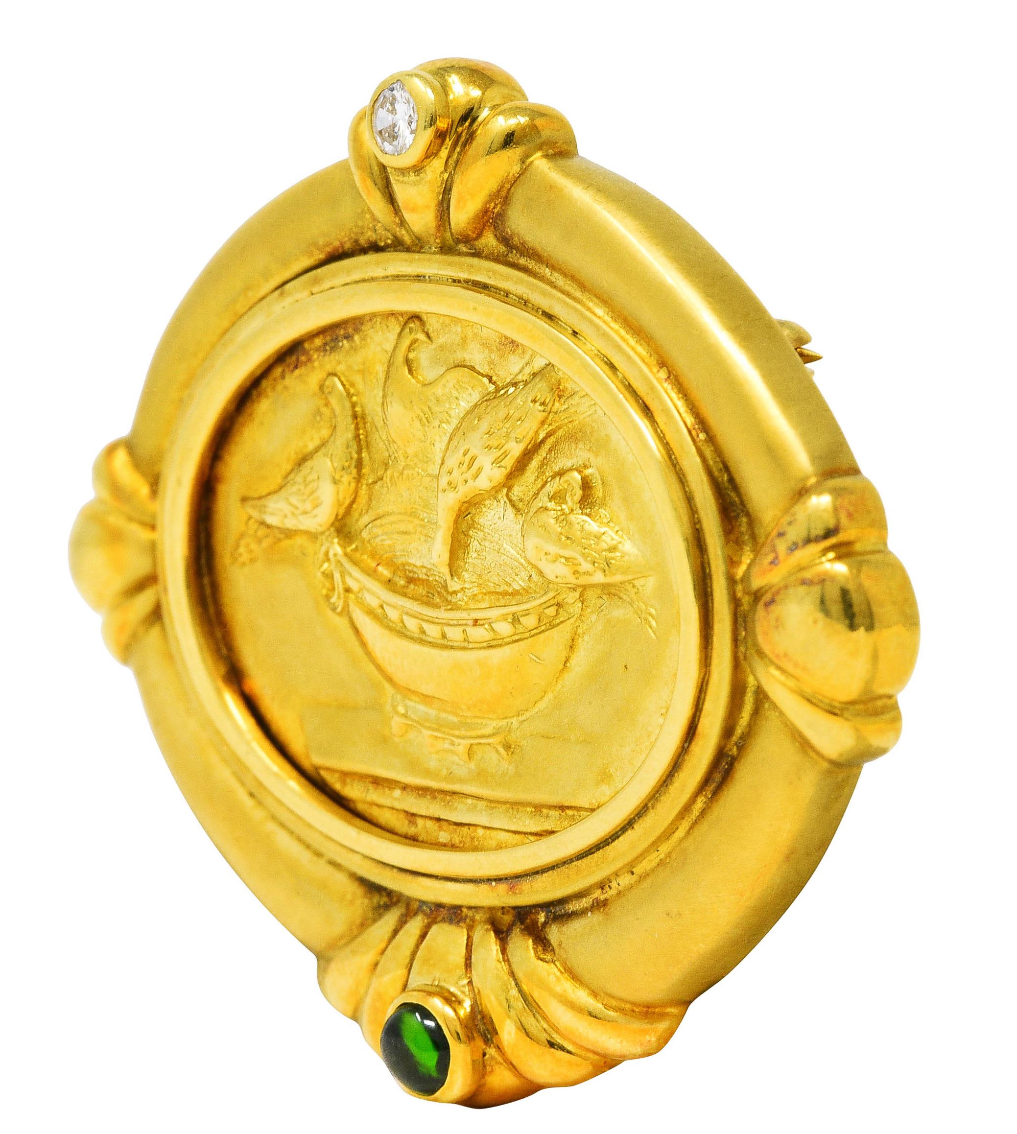 Brooch centers a highly rendered gold cameo of four doves in a bird bath on a pedestal

With decorative fluted gold frame surround featuring a bezel set round brilliant cut diamond

Weighing approximately 0.10 carat total - eye clean and