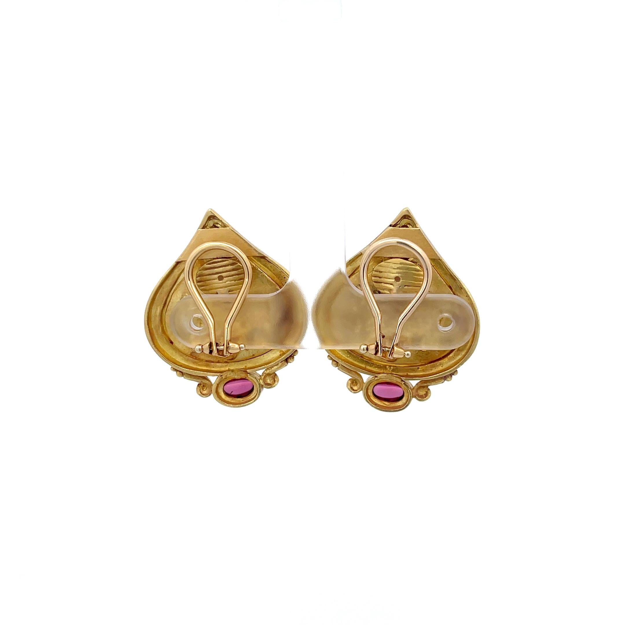 Seidengang Horse Scene Pink Tourmaline Earrings in 18K Yellow Gold. The earrings feature two bezel set oval cabochon pink tourmalines. Omega backs. 
18.21 Grams
1.25