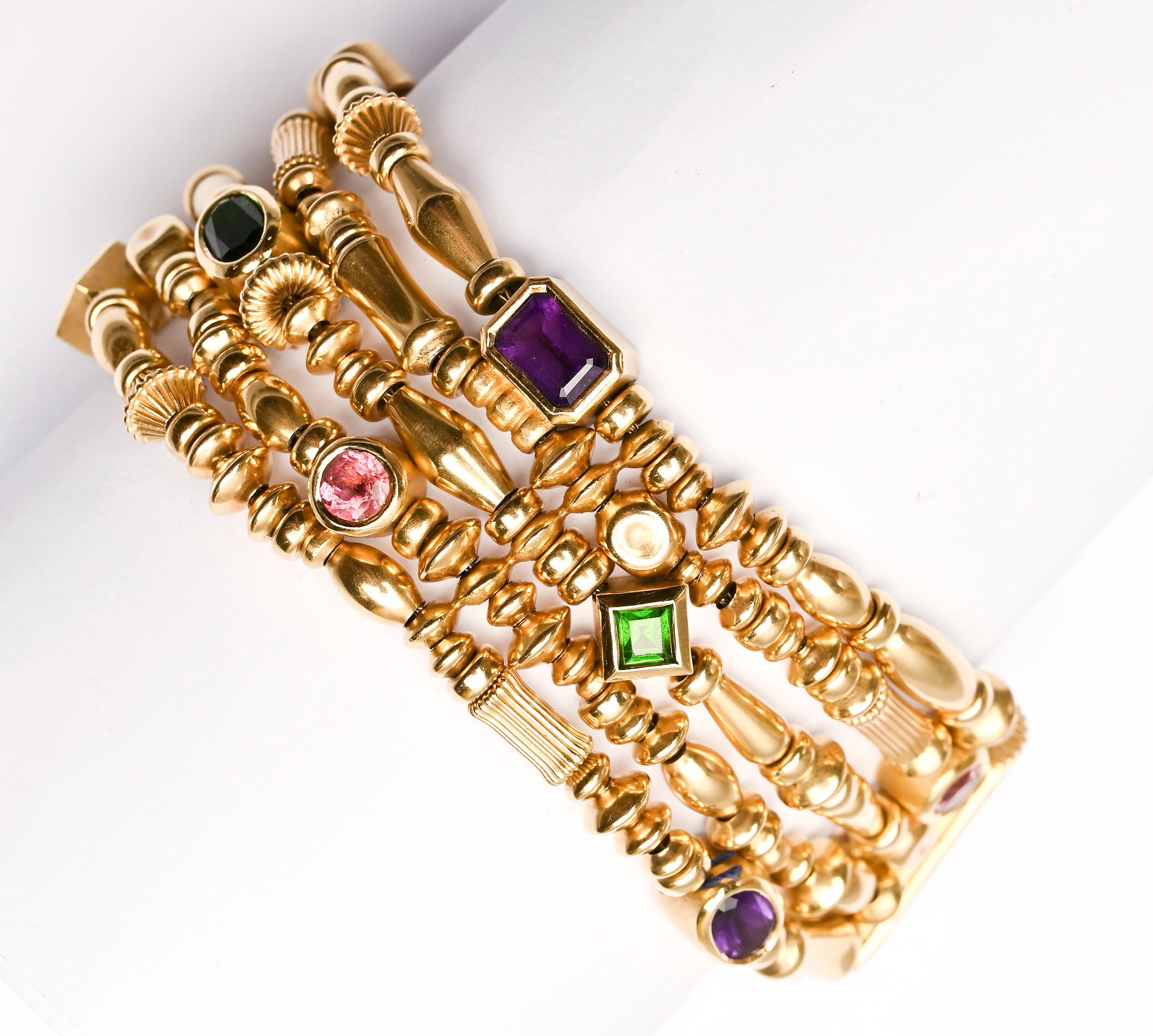 Seidengang bracelet of five strands of gold beads of varying shapes and sizes. Interspersed with the beads are square; round; oval and rectangular stones that include tourmaline; citrine and amethyst. The bracelet is 7 1/8 inches long and 1 inch