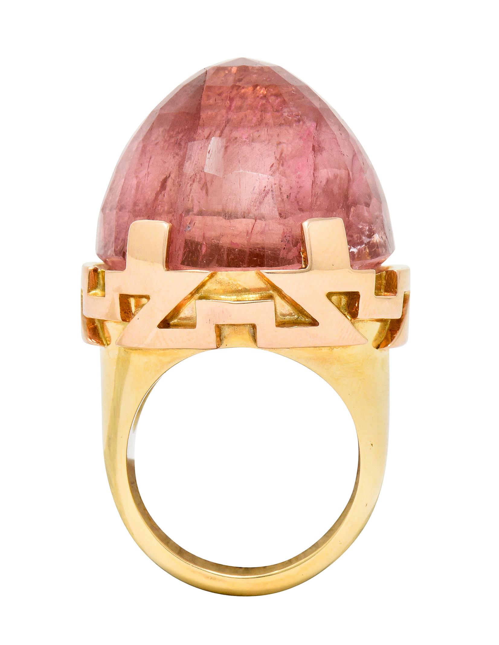 Centering a substantial checkerboard cut pink tourmaline, reverse set as a high dome, measuring approximately 25.9 x 24.0 mm

A very saturated bubble gum pink color and translucent with natural inclusions

Set by wide prongs and features a stylized