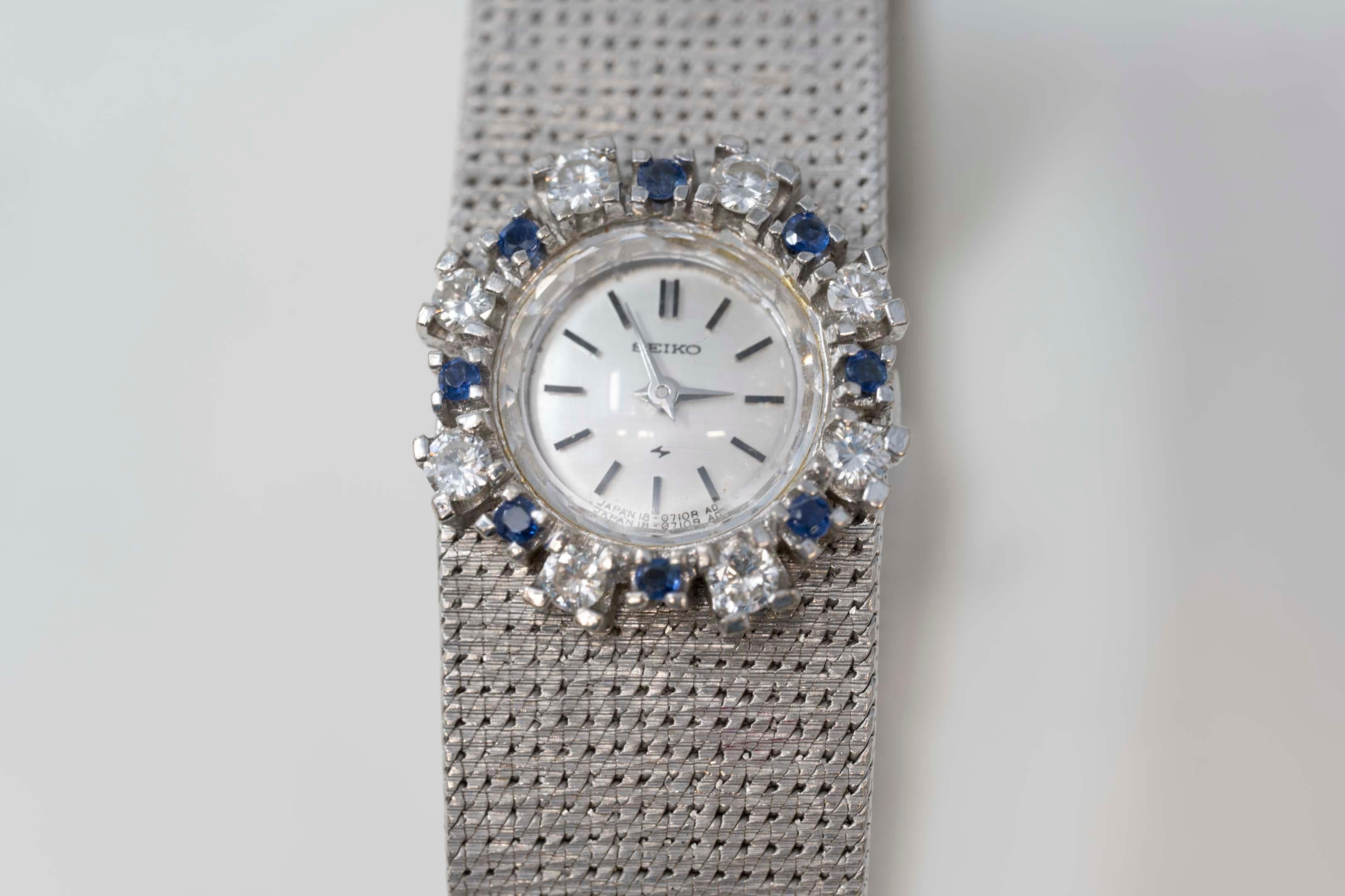 Vintage Seiko 14k white gold watch and bracelet, mechanical movement set with 8 diamonds full cut VS-VVS and G-H color for a total of .65ct. 8 Sapphire natural stones, case #2823, stamped 14k, measures 7 inches long. In good working order. Preowned,