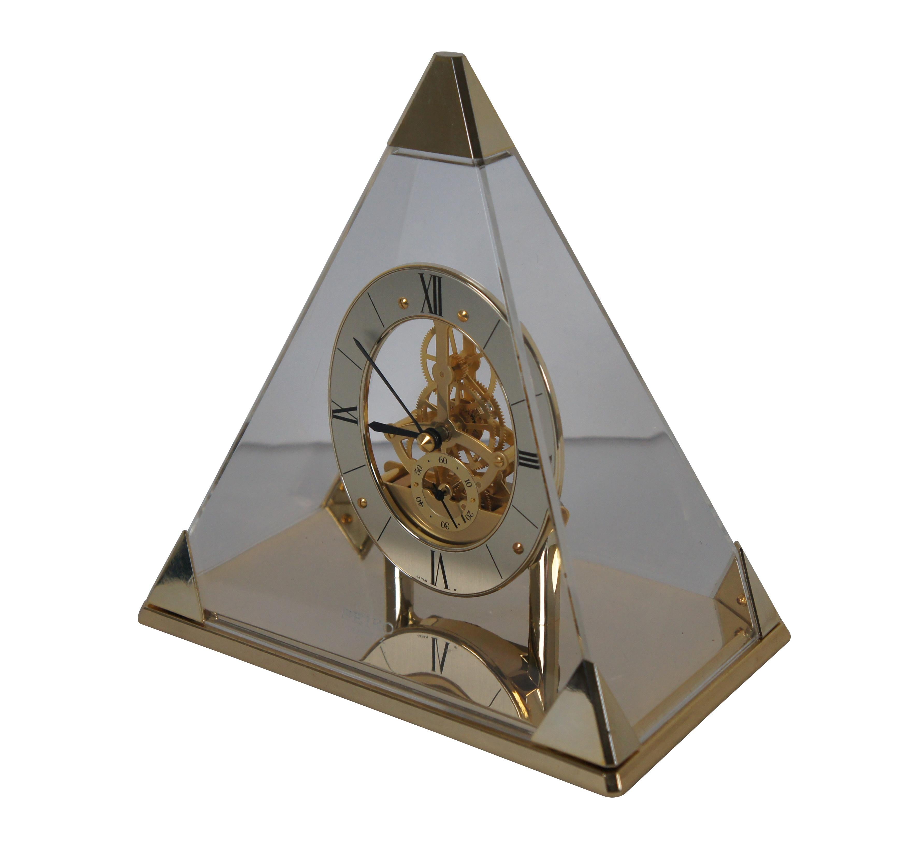 Vintage Japanese Seikosha Co Ltd brass pyramid skeleton clock featuring a lucite triangle dome top and roman numeral face.

Dimensions:
8.25
