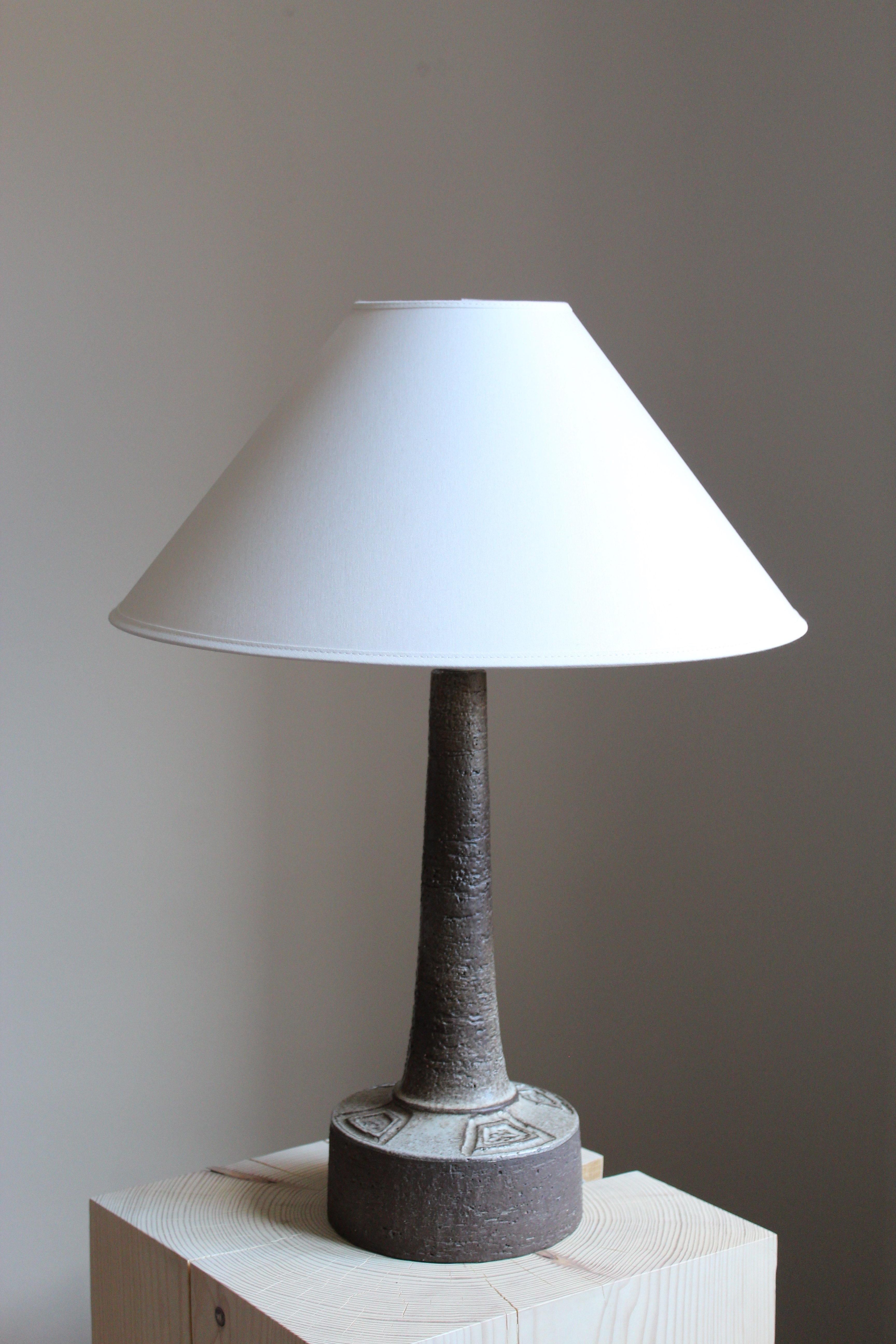 A small table lamp produced by Sejer Keramik, Denmark, 1960s

Glaze features grey-black colors.

Sold without lampshade. Stated dimensions excluding lampshade and lightbulb.
  