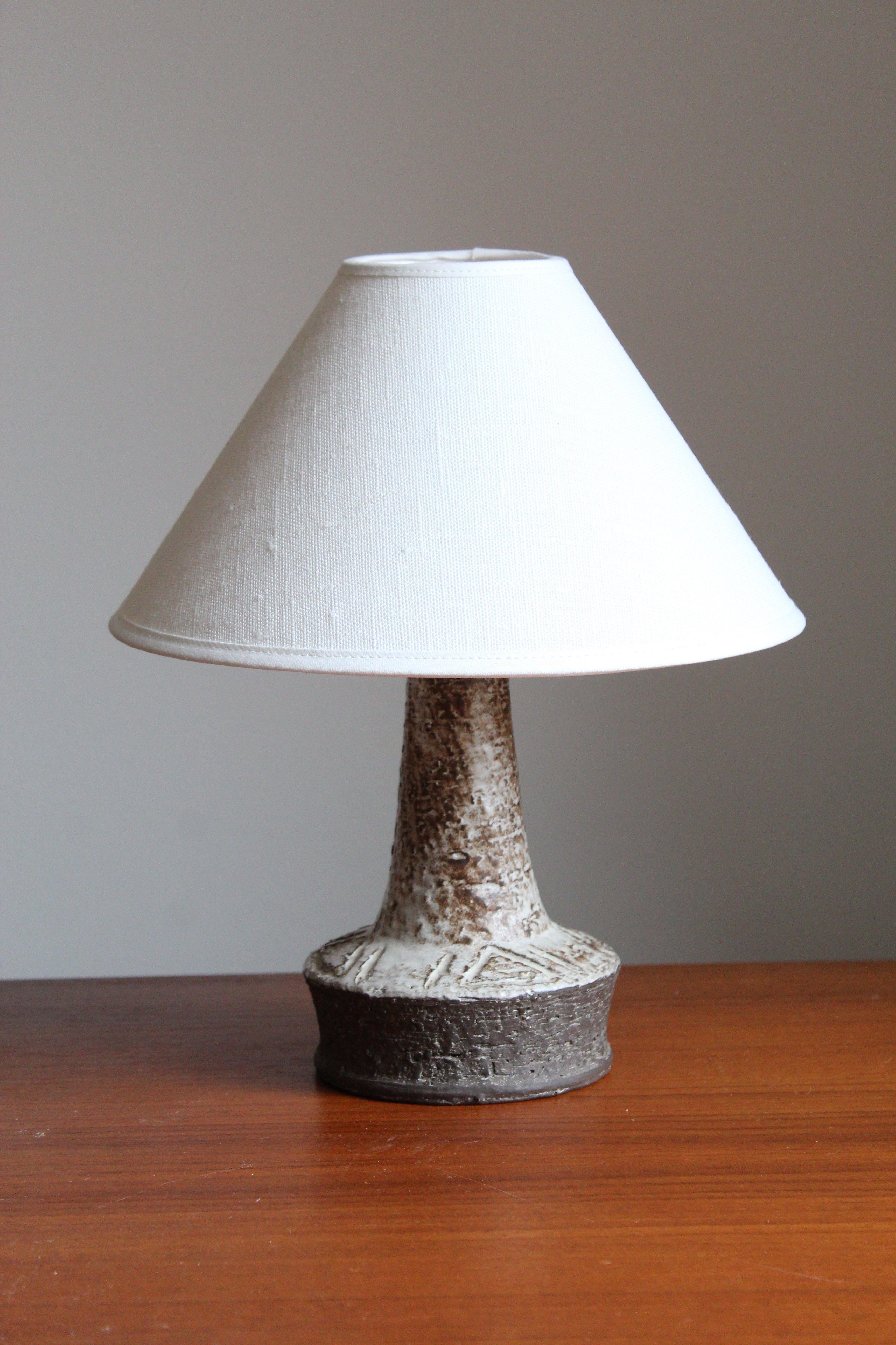 A table lamp produced by Sejer Keramik, Denmark, 1960s. Features simple incised decoration.

Sold without lampshade. Stated dimensions excluding lampshade.
 