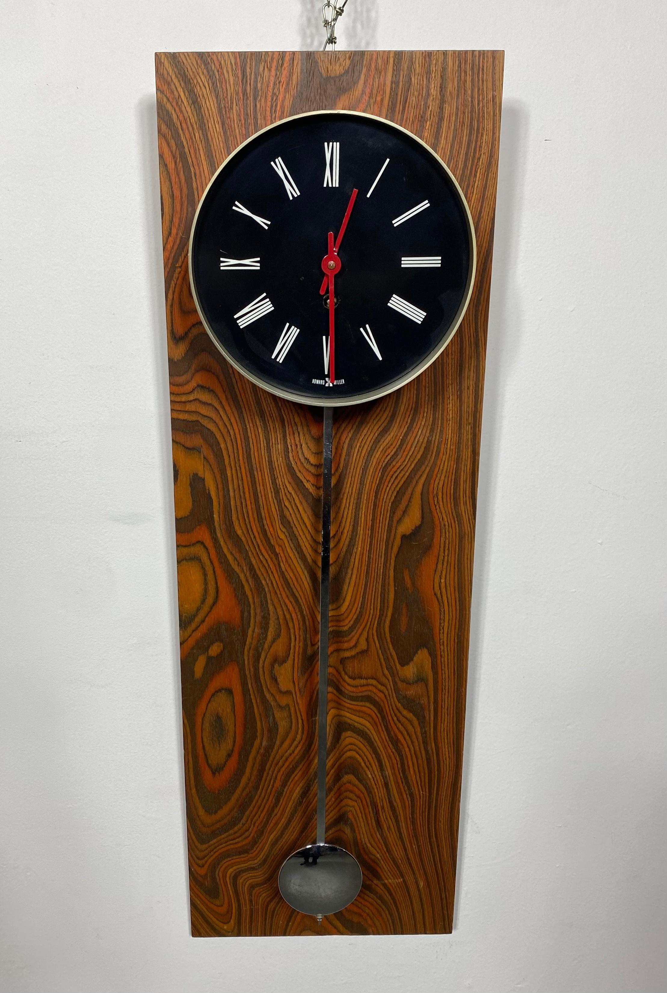 Seldom seen exotic wood Modernist wall clock by Howard Miller.. Wonderful exotic zebra wood, excellent original condition, tested and working, classic modernist design.