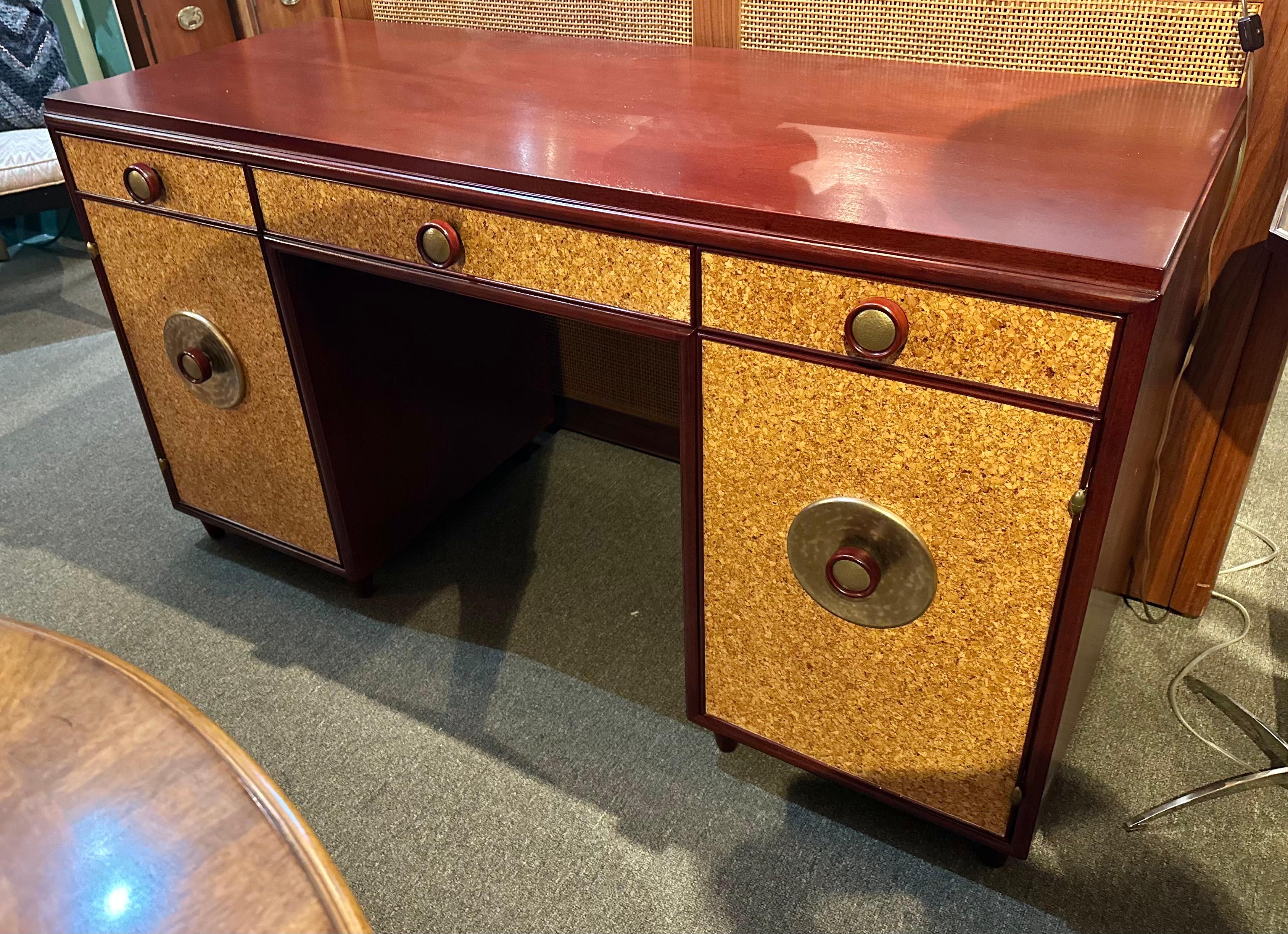 Stunning mahogany and cork  Mid-Century desk by Paul Frankl with three drawers above two cabinets, one fitted with pull out drawers and branded with
