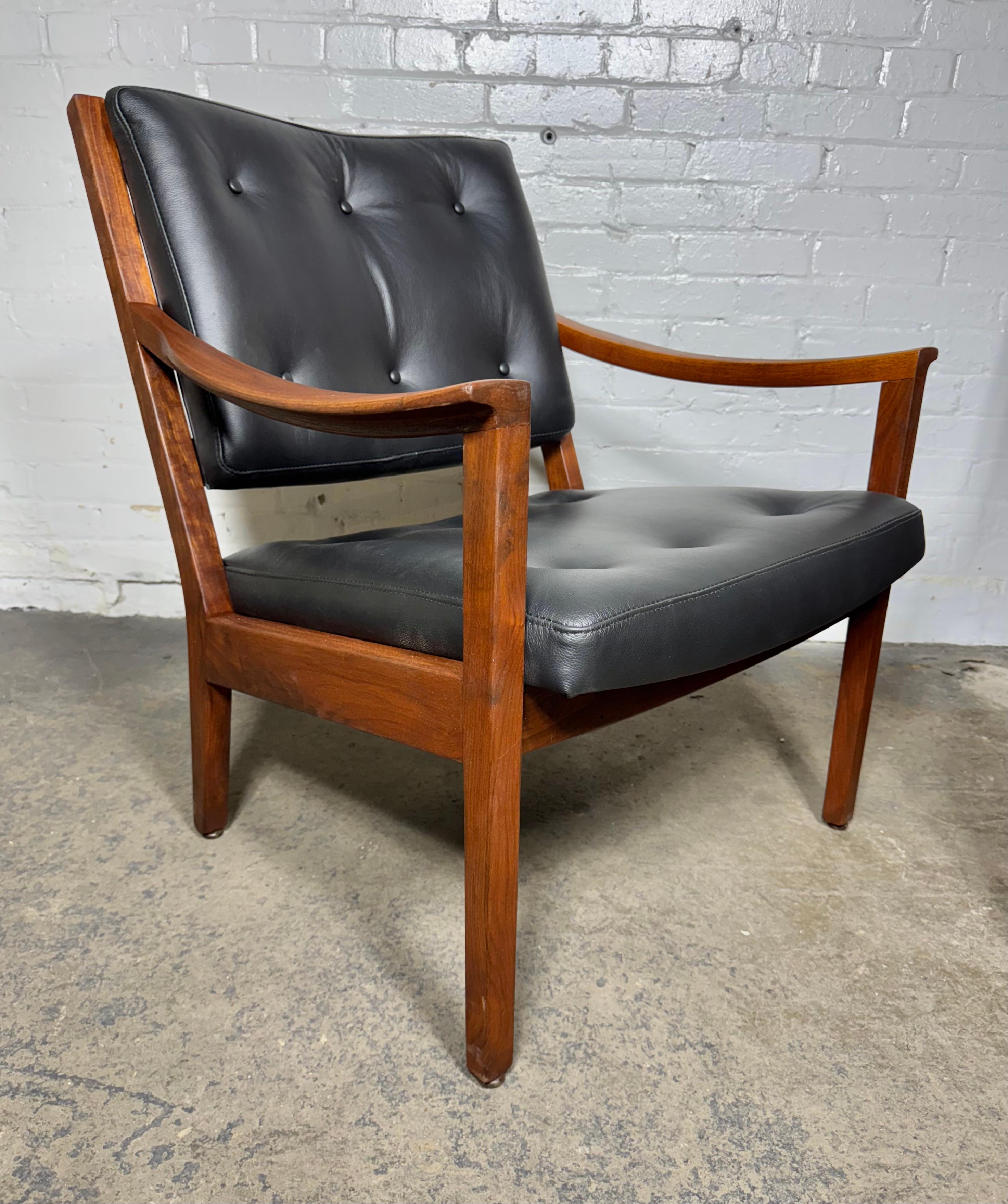 Stunning pair modernist walnut and leather lounge chairs made by Gunlocke,, Professionally restored,, solid Figured walnut wood frame, totally  refinished.  quality , high end Black leather seat and back..newly .reupholstered. Great design.Jens
