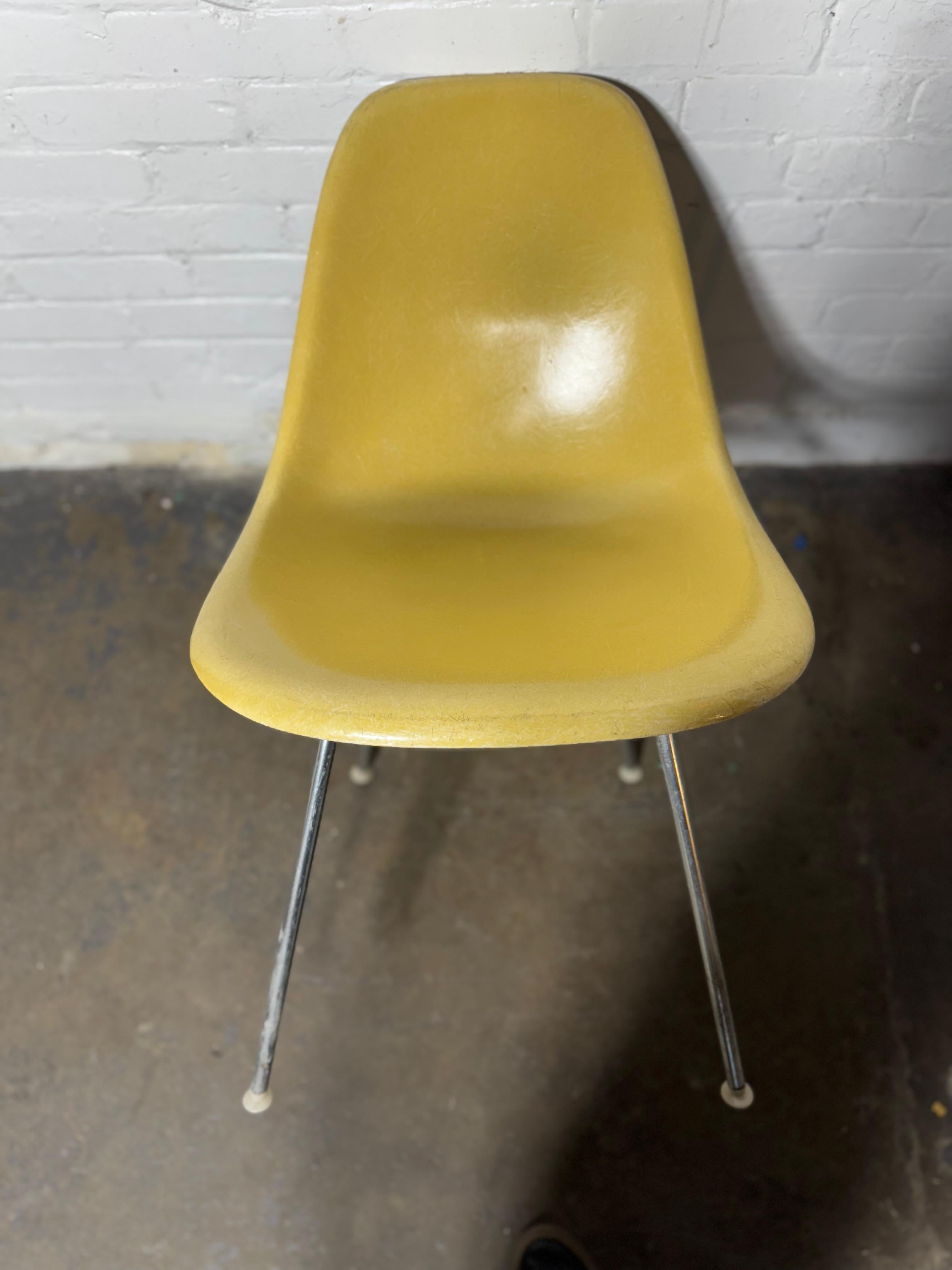 Iconic chair designed by Charles & Ray Eames for Herman Miller. Molded fiberglass shell in seldom seen Ochre Light Color..  Mounted on vintage black steel H-base. chair in very good vintage condition with small signs of wear. Appears to be all