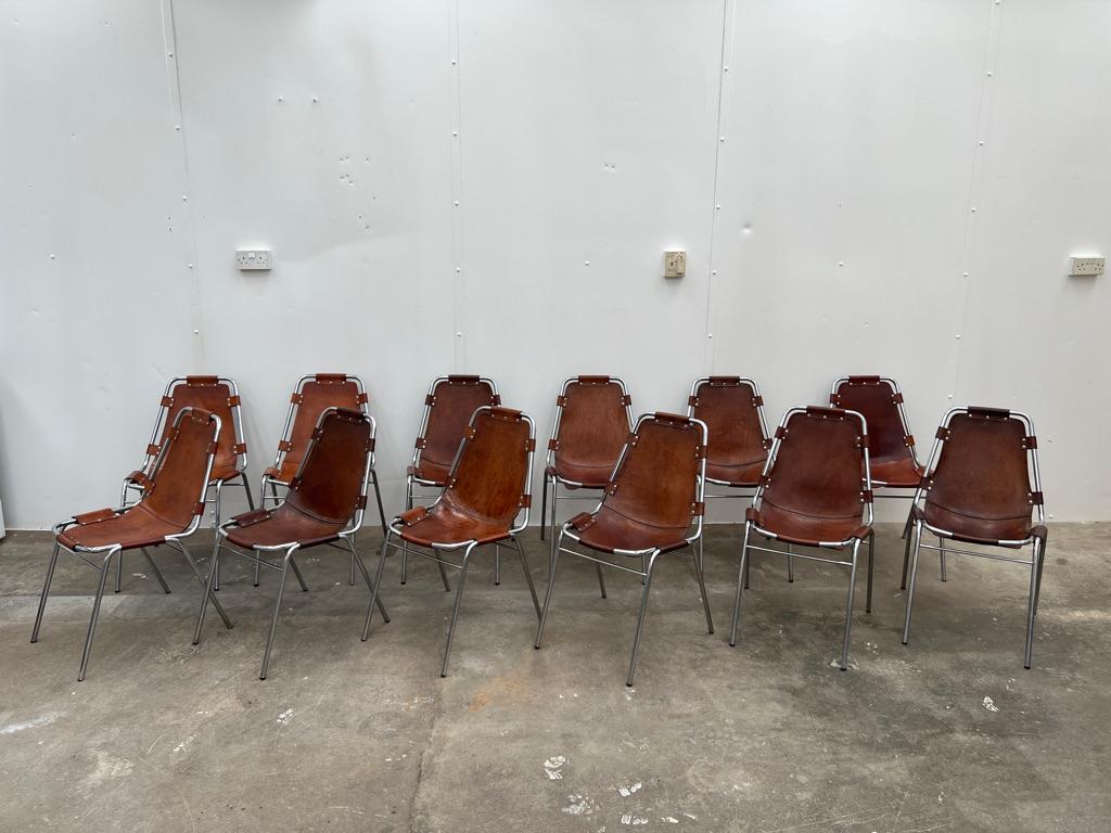 Stunning set of chairs, you will not find another set of 12 chairs like this one on any web site worldwide! Selected by Charlotte Perriand for Les Arcs Ski Resort, circa 1960. Very nice chrome tubular frame with thick brown leather seats.
 
These