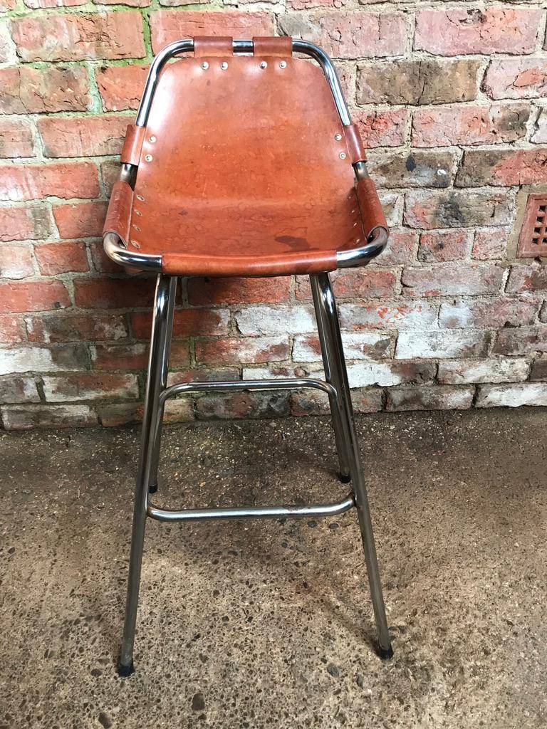 Stunning stool, designer Charlotte Perriand used these in the Ski Resort Les Arcs, circa 1960. This stool was commissioned to be made by Cassina, one of the best Italian furniture maker’s very nice chrome tubular frame with thick leather seat, which