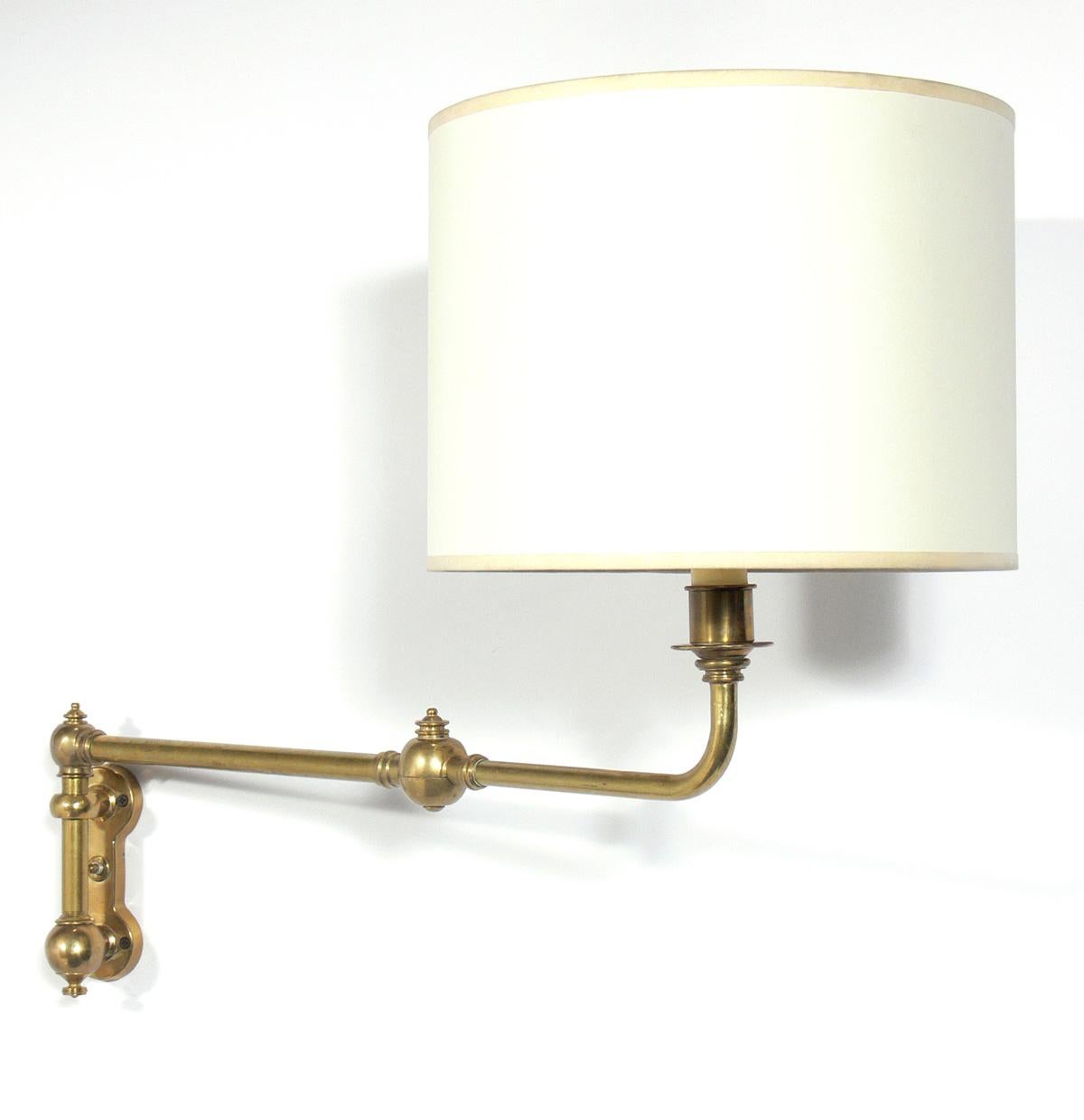 Selection of Brass Swing Arm Sconces, American, circa 1960s. They are:
1) Brass sconces, pictured on the top of the first photo. They measure 26