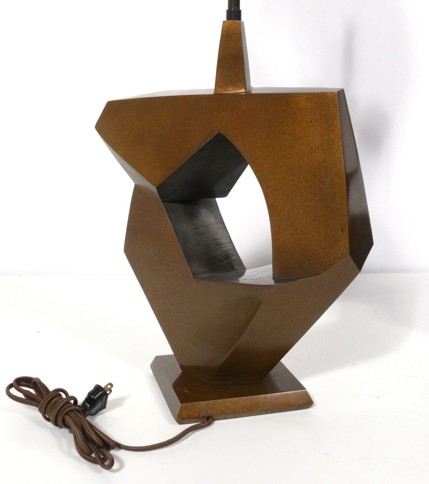 Selection of bronze modernist lamps, American, circa 1950s-1990s. From left to right, they are:
1) Abstract solid bronze lamp, signed, numbered, and dated by the artist, Stanton, from a limited edition 18/500, produced in 1998. It measures 27