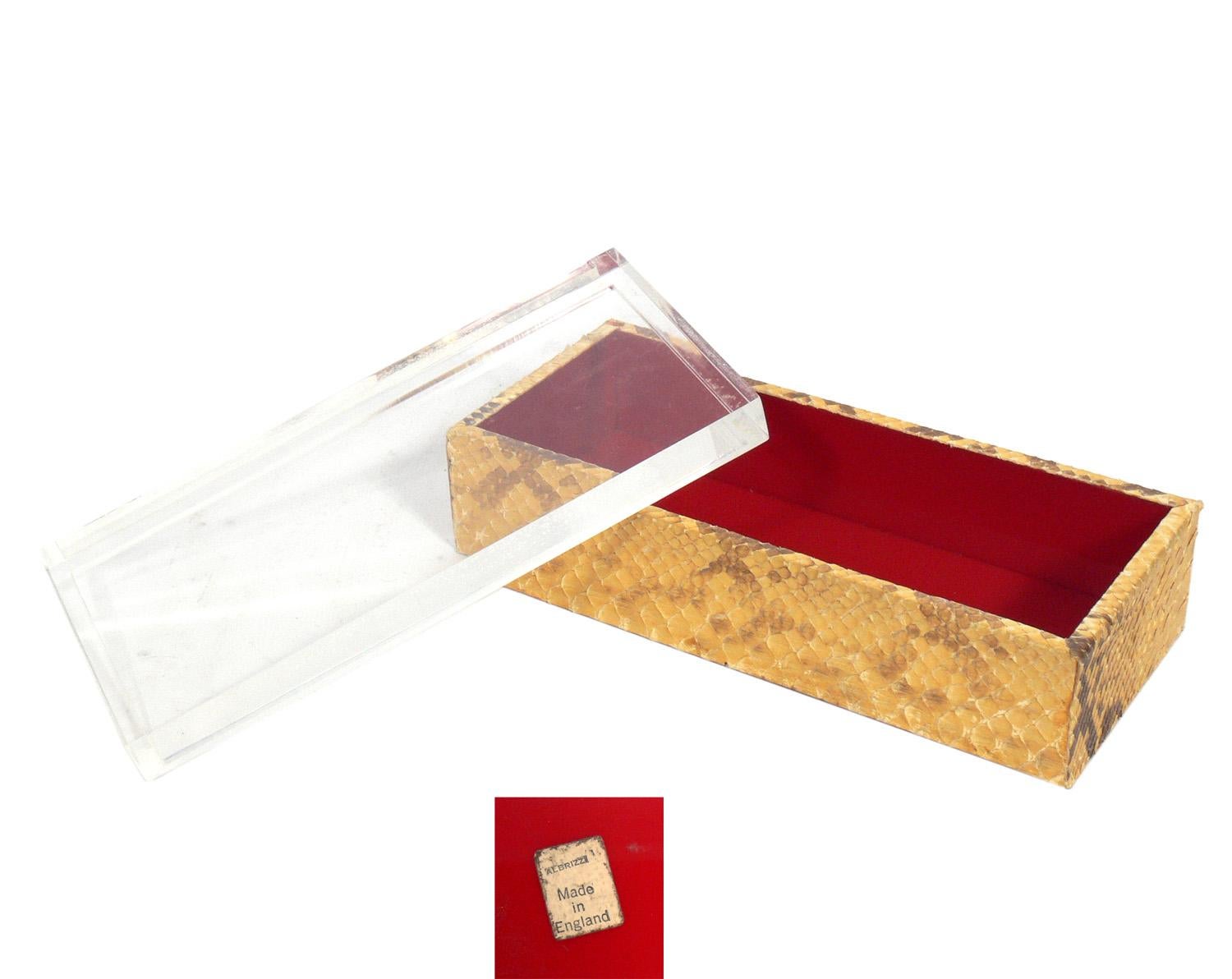 Selection of modernist boxes, circa 1950s-1980s. They are, from left to right as seen in the first photo:
1) Python skin and lucite red lacquered box, England, circa 1950s. It measures 3