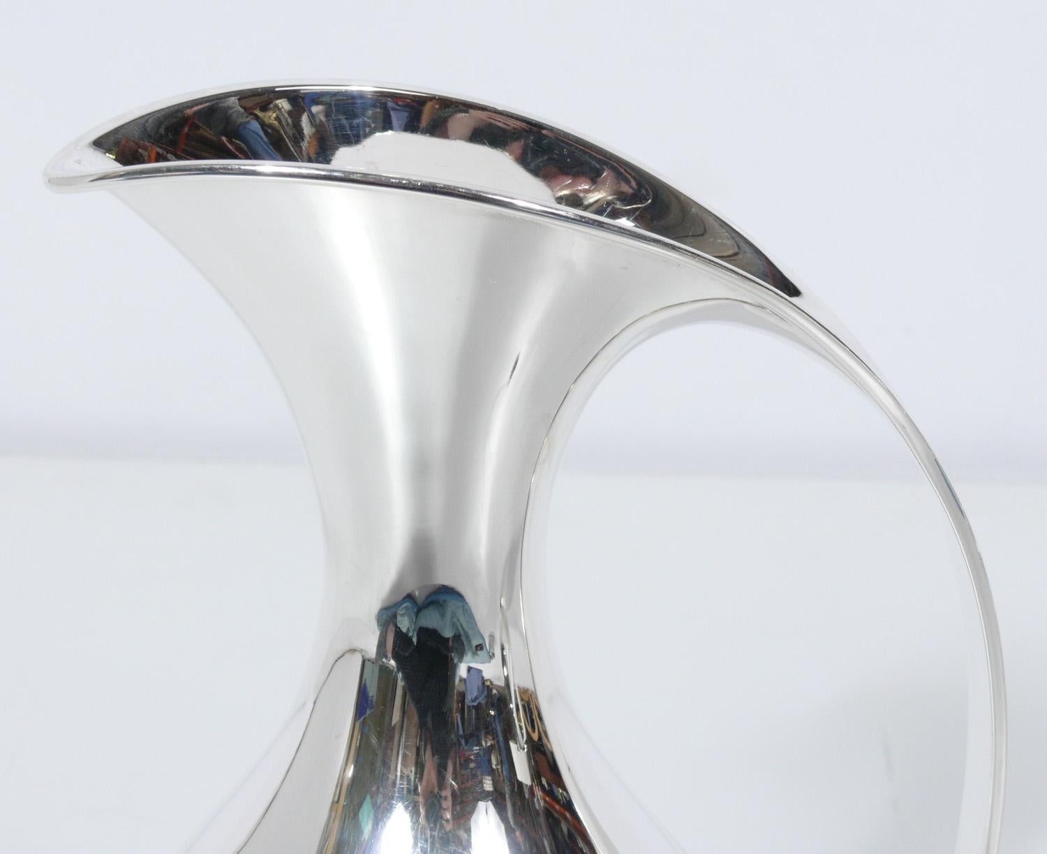 Selection of sculptural Danish modern sterling pitchers, designed by Kay Fisker for A. Michelsen, Denmark, circa 1930s. Signed with impressed manufacturer's mark to underside: [A. Michelsen Copenhagen S Kay Fisker L.9 1.5L Sterling Denmark].