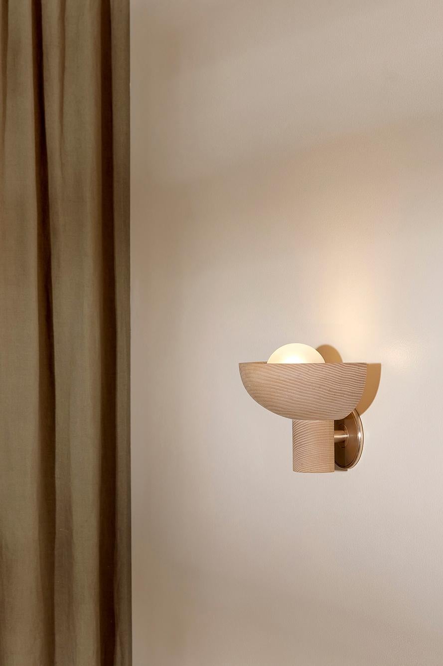 The Selene Uplight is crafted from a quarter timber dome that sits atop a cylinder derived from the FSC certified timber offcuts from our Terra 00 range. Featuring a unique handmade set of components, the wall-mounted Selene Uplight in Ash, Bleached