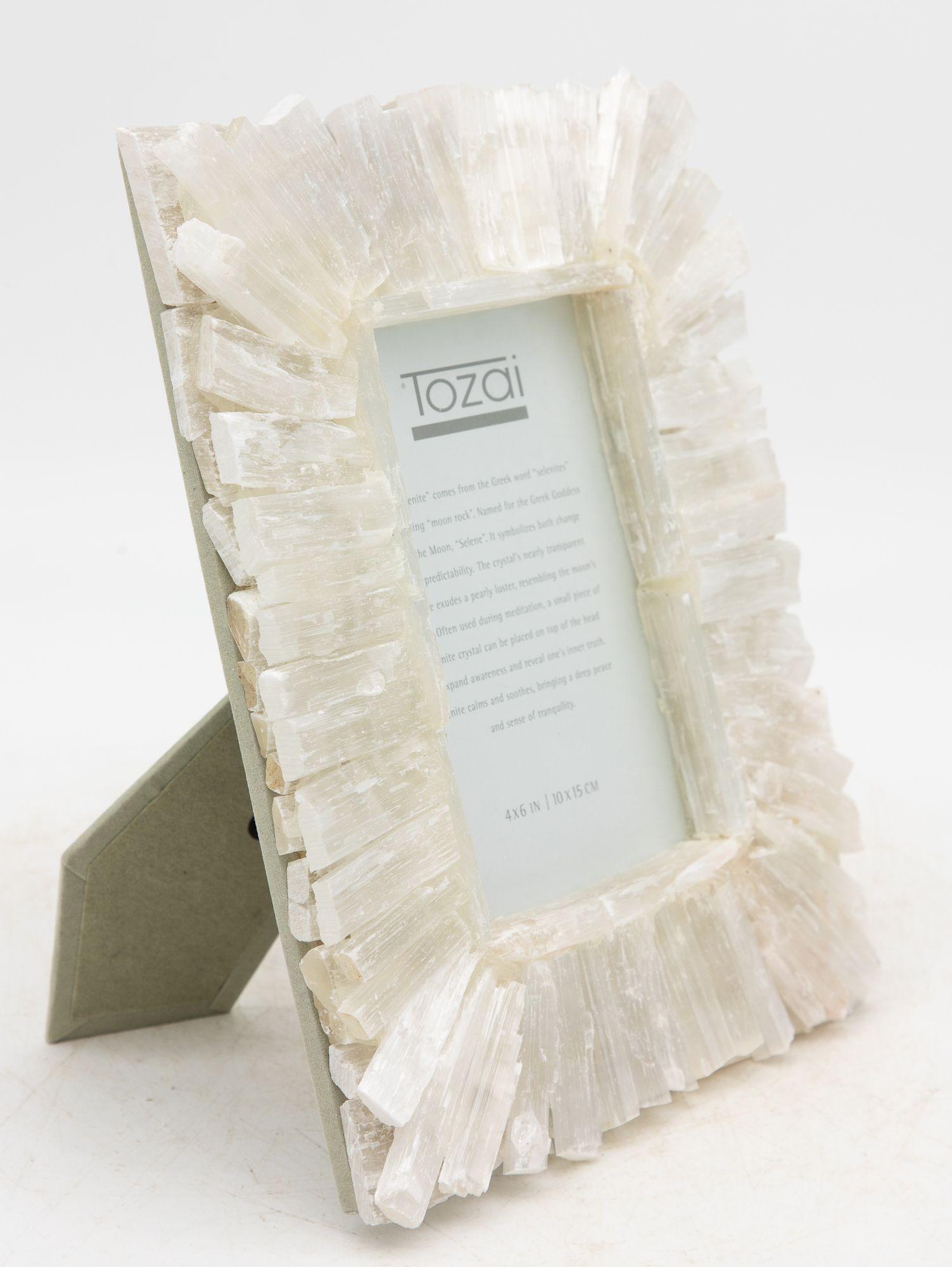 Cool and luminous, the Selenite frame shimmers with a moonlit glow, its crystalline surface radiating calm elegance. Holds a 4