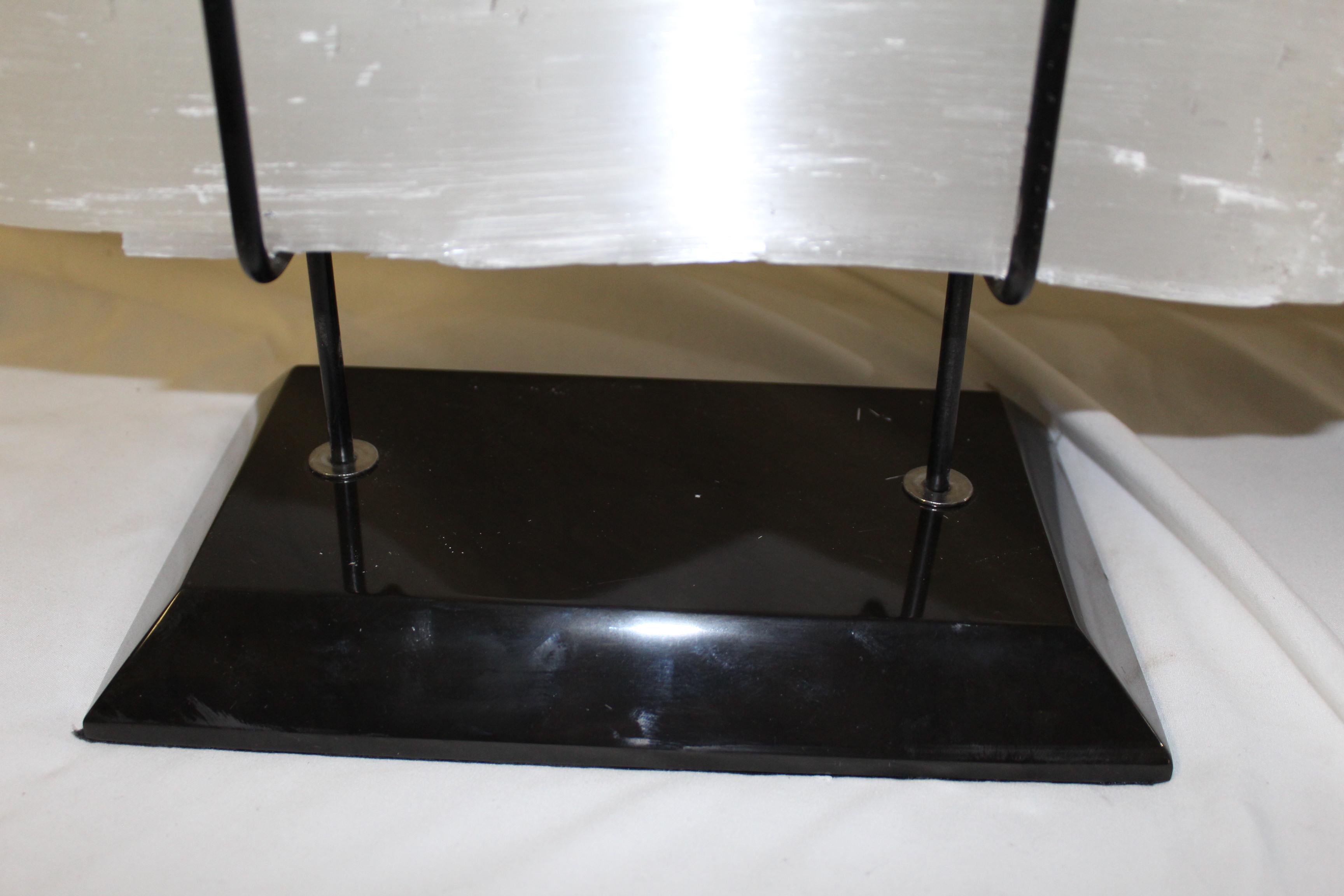 Large piece of selenite stone mounted on a custom made stand with absolute black marble base. Measure: 19