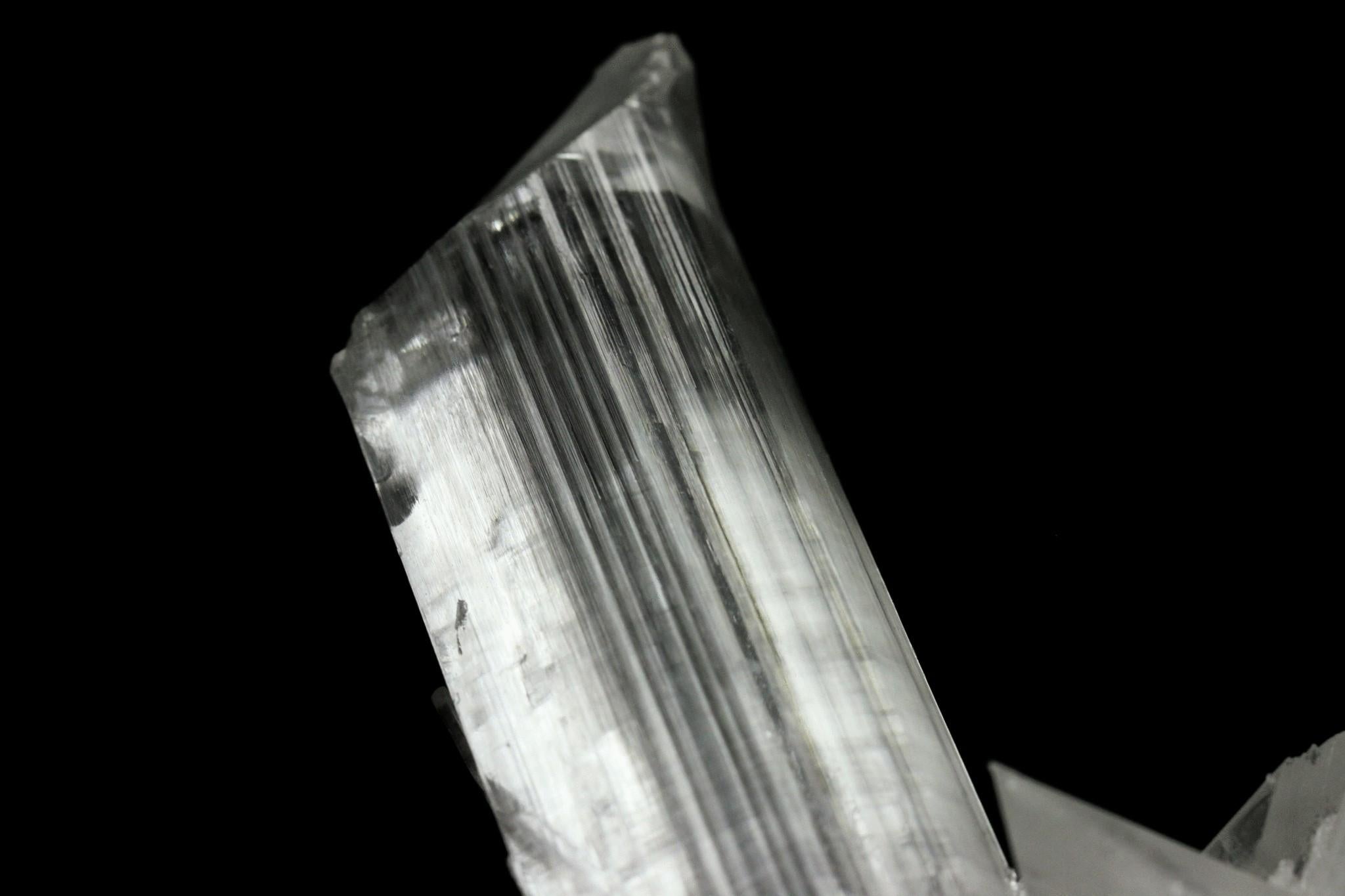 From Naica Mine, Naica, Mun. de Saucillo, Chihuahua, Mexico

Aesthetic specimen of a transparent 4'' selenite wand perched atop a luster of stark white gypsum selenite blades. The selenite crystal has great transparency, terminated with striated