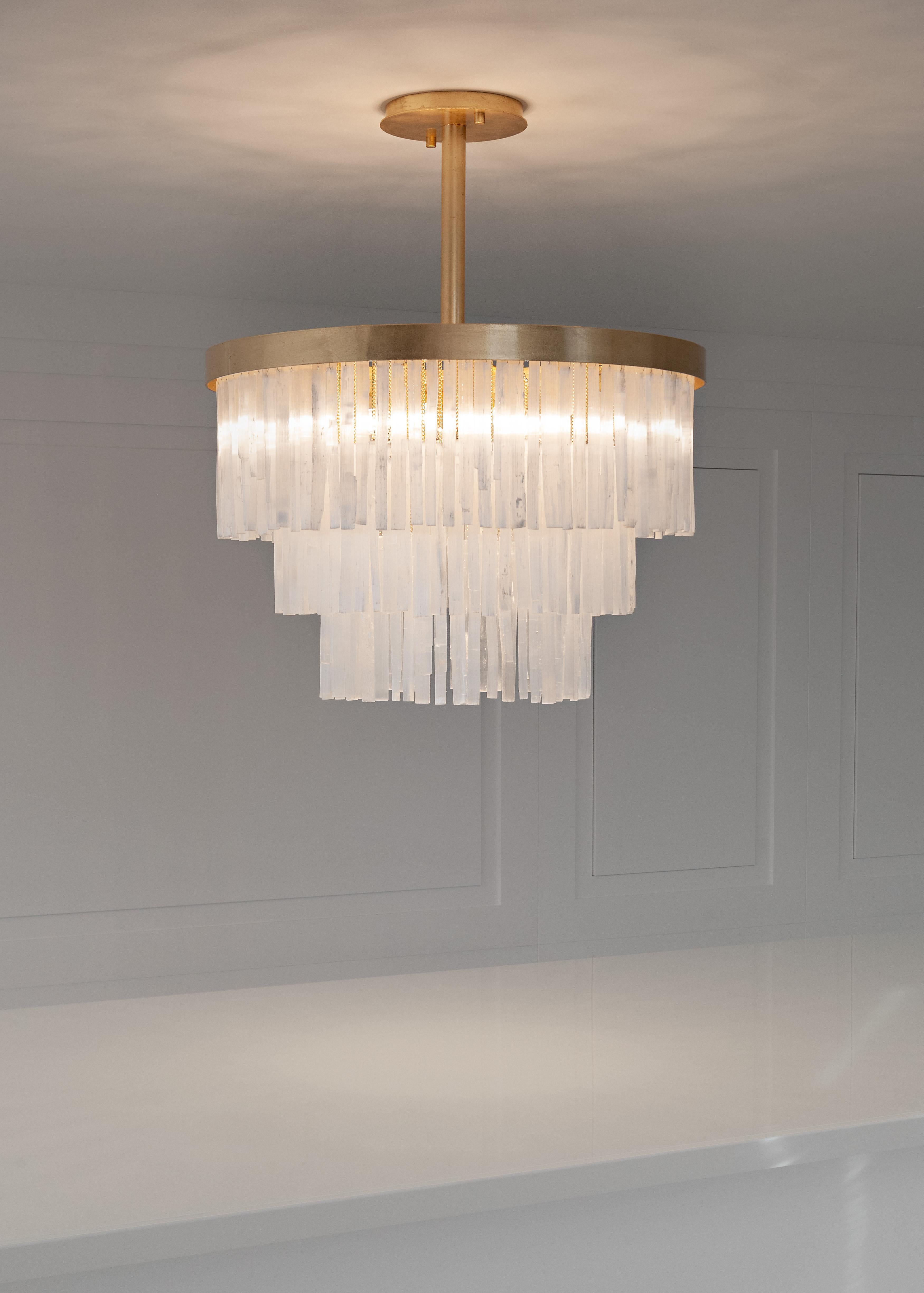 Selenite chandelier by Aver
Dimensions: 80 x 80 x 60cm
Materials: Aluminum and selenite

Designed by Marcele Muraro, it is made of natural stones and inspired by the city of Casablanca, which has a rich Art Deco architectural heritage. Straight and