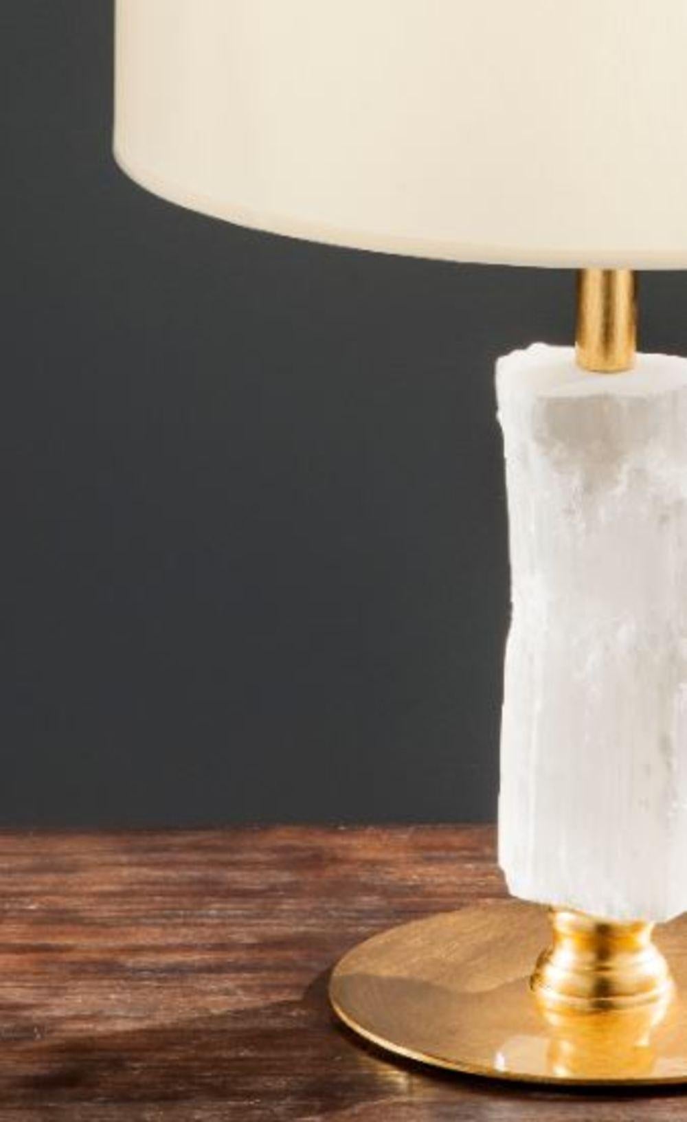 Selenite table lamp by Aver
Dimensions: 40 x 40 x 64cm
Materials: Aluminum and selenite

Designed by Marcele Muraro, it is made of natural stones and inspired by the city of Casablanca, which has a rich Art Deco architectural heritage. Straight and