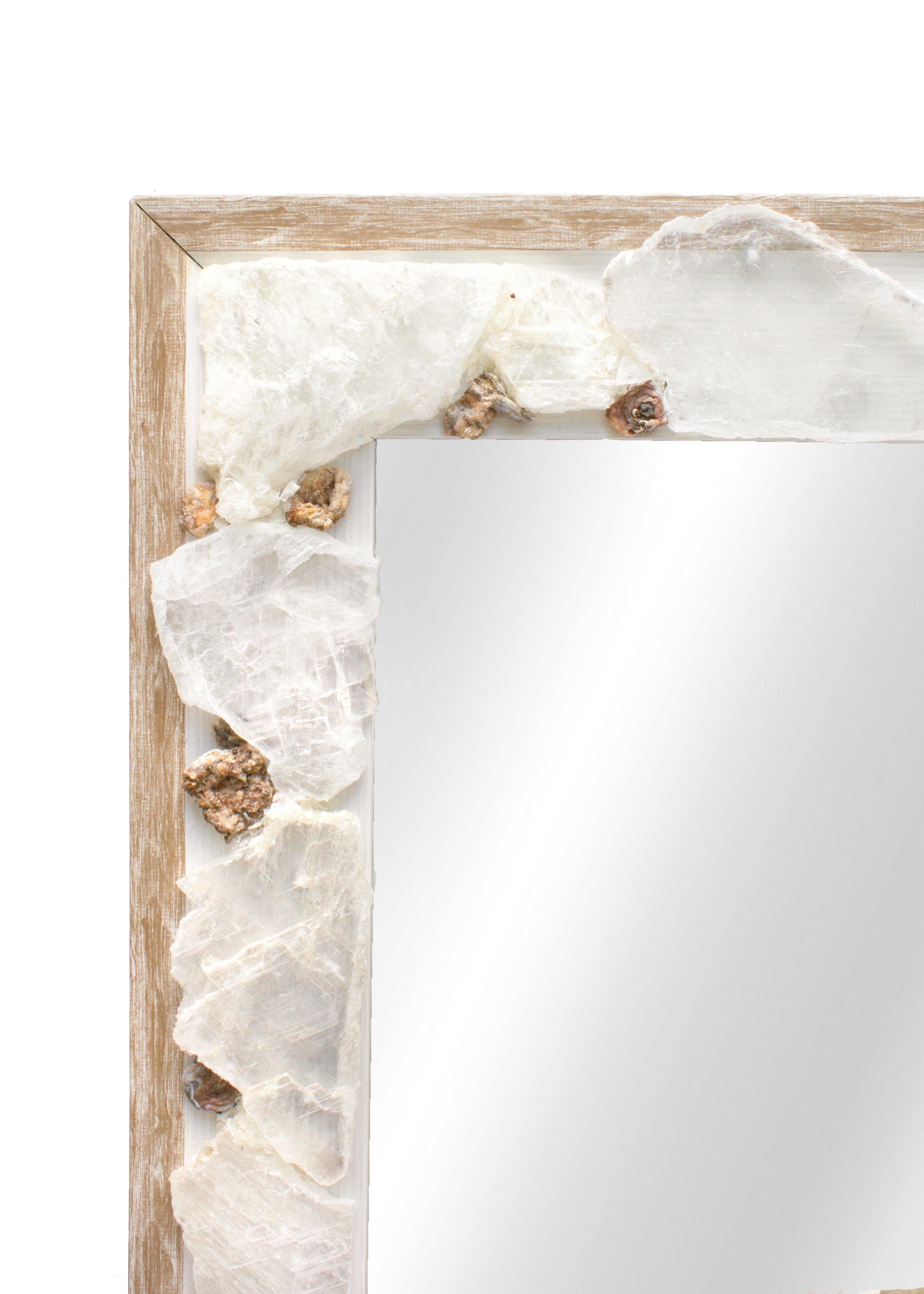 Selenite slice mirror with coordinating chalcedony rosettes.

Selenite is a crystallized form of gypsum. This crystalline form of selenite gypsum is comprised of striations which look like optical light fibers. Although selenite comes in many