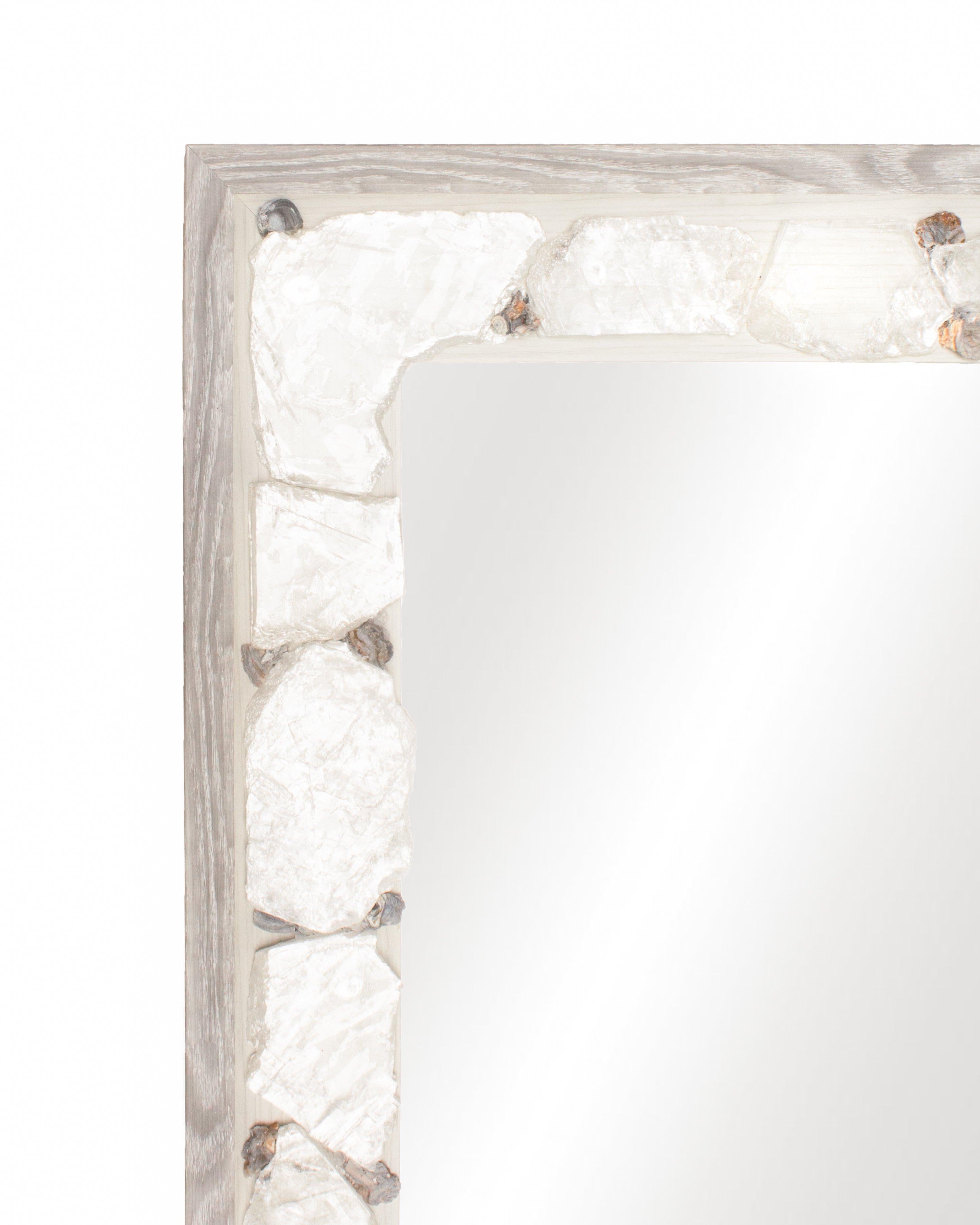 Grey and white limed mirror with selenite slices and chalcedony rosettes.

Selenite is a crystallized form of Gypsum. It is comprised of striations which look like optical light fibers. Although selenite comes in many forms, selenite slices have a