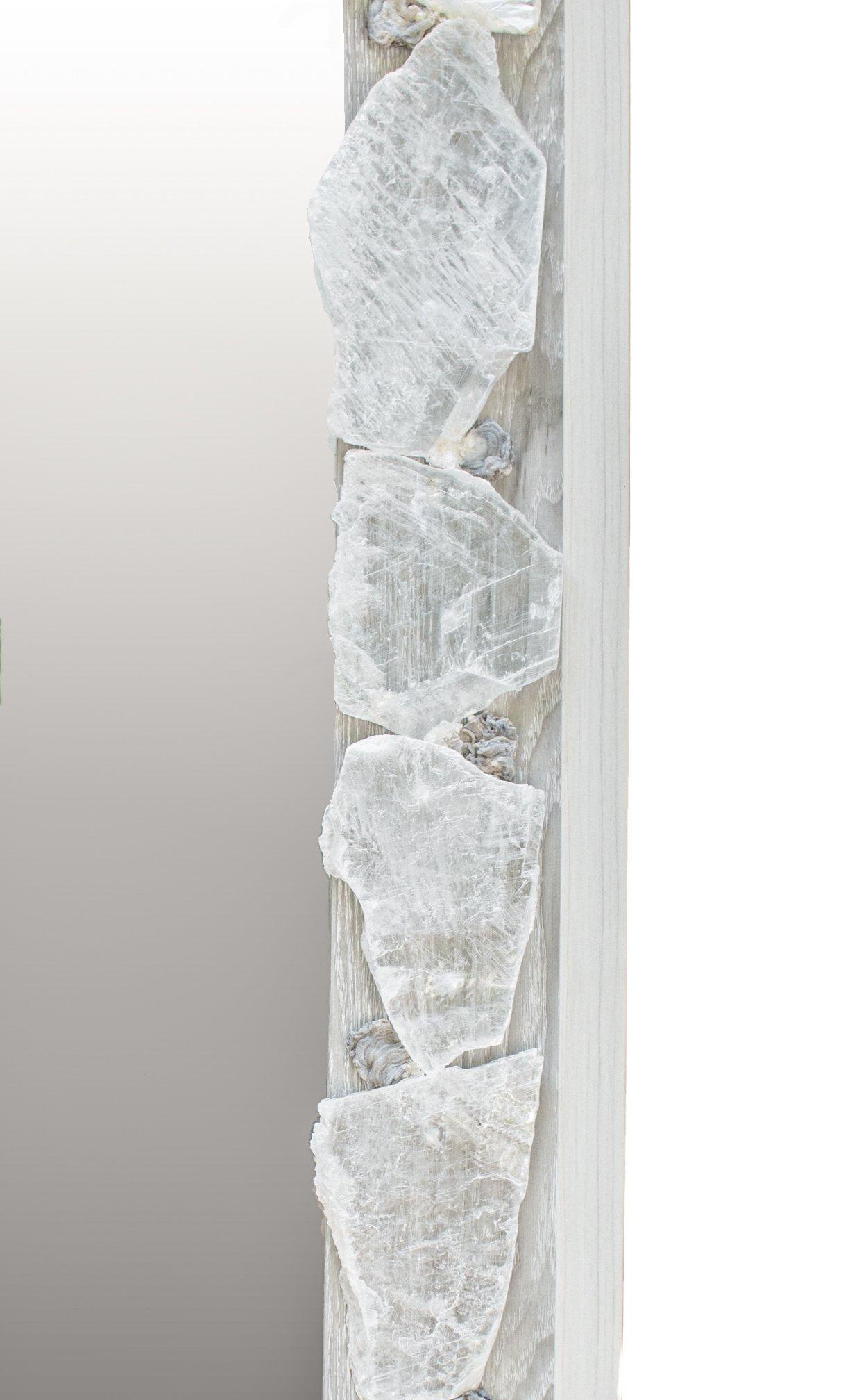Mirror decorated with selenite slices and chalcedony rosettes.

Selenite is a crystallized form of Gypsum. It is comprised of striations which look like optical light fibers. Although selenite comes in many forms, selenite slices have a unique