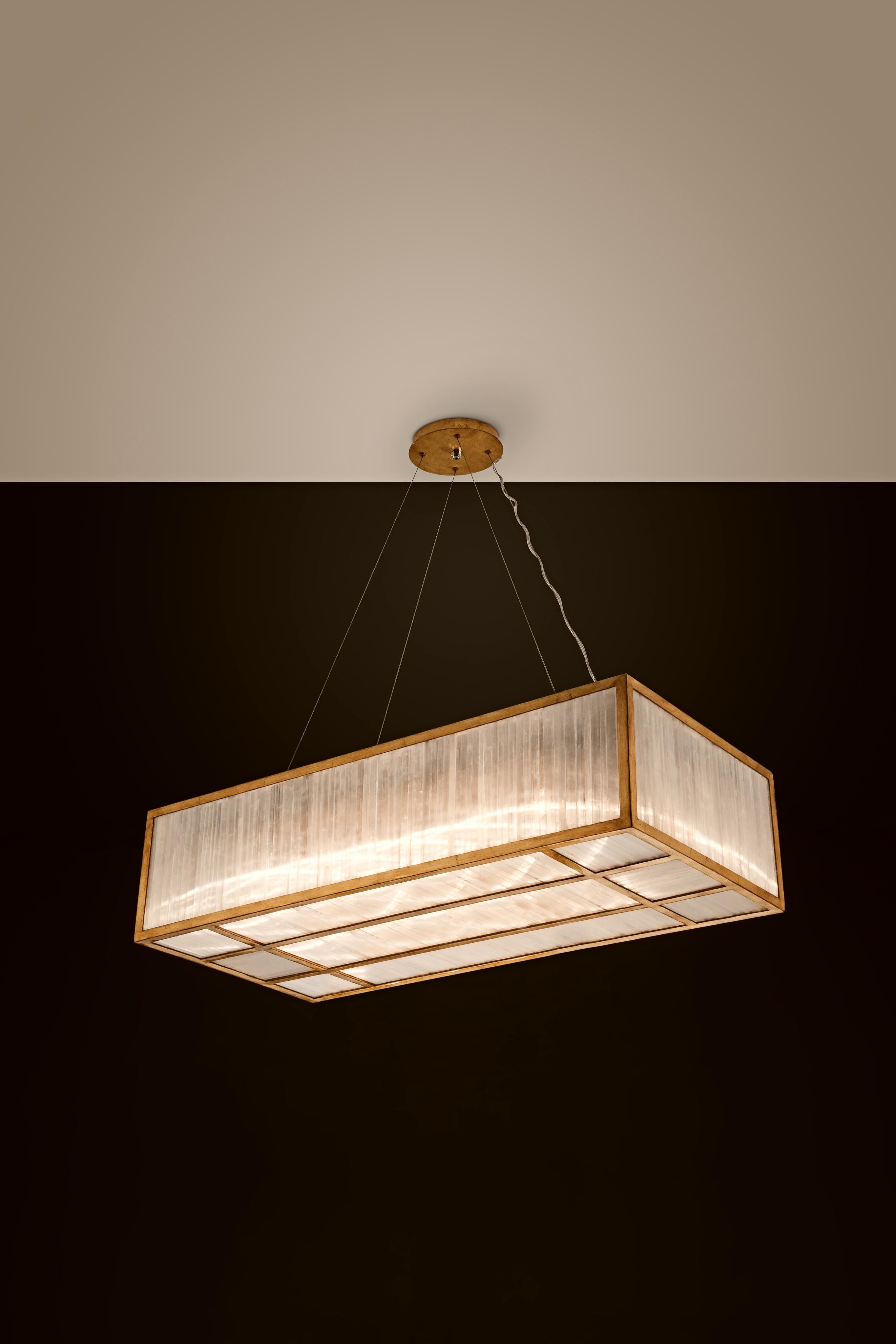 Selenite rectangular pendant lamp By Aver
Dimensions: D 50 x W 100 x H 25 cm
Materials: Selenite, metal.
Also available: silver leaf, antique silver leaf, gold leaf, brass leaf, copper leaf, pink gold leaf.

Cylindrical pendant with a beautiful