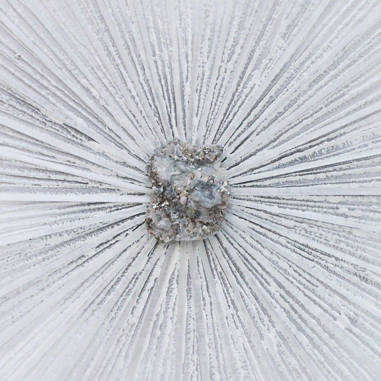 Grey and white acrylic painted canvas with a selenite crystal sunray and a chalcedony rosette center. Chalcedony rosettes are crystal deposits that form under the earth. They are known for their druzy and sparkle. The selenite crystals have been