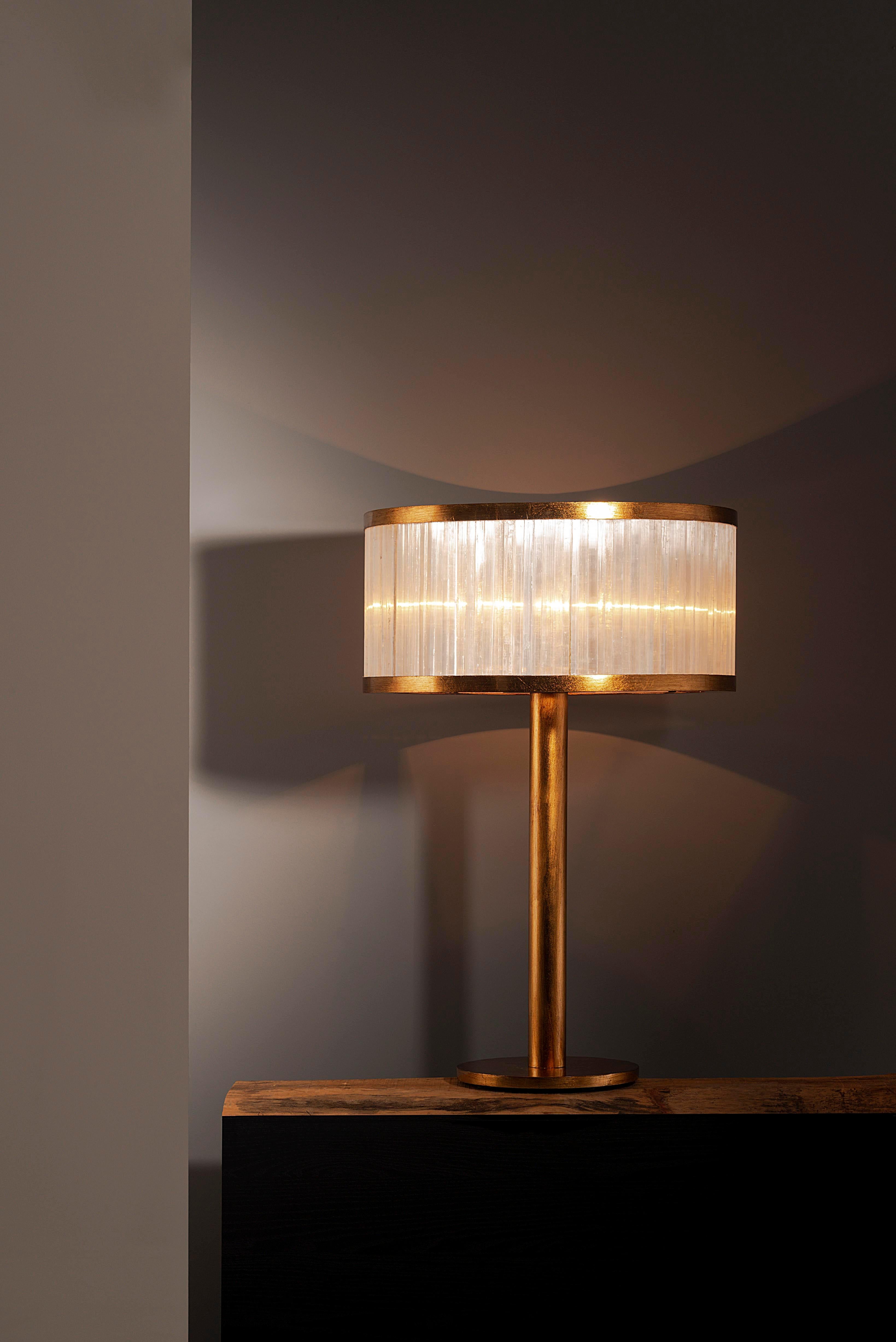 Selenite table lamp by Aver
Dimensions: D 50 x H 74 cm
Materials: Selenite, metal.
Also Available: silver leaf, antique silver leaf, gold leaf, brass leaf, copper leaf, pink gold leaf.

Cylindrical table lamp with a beautiful manual work done