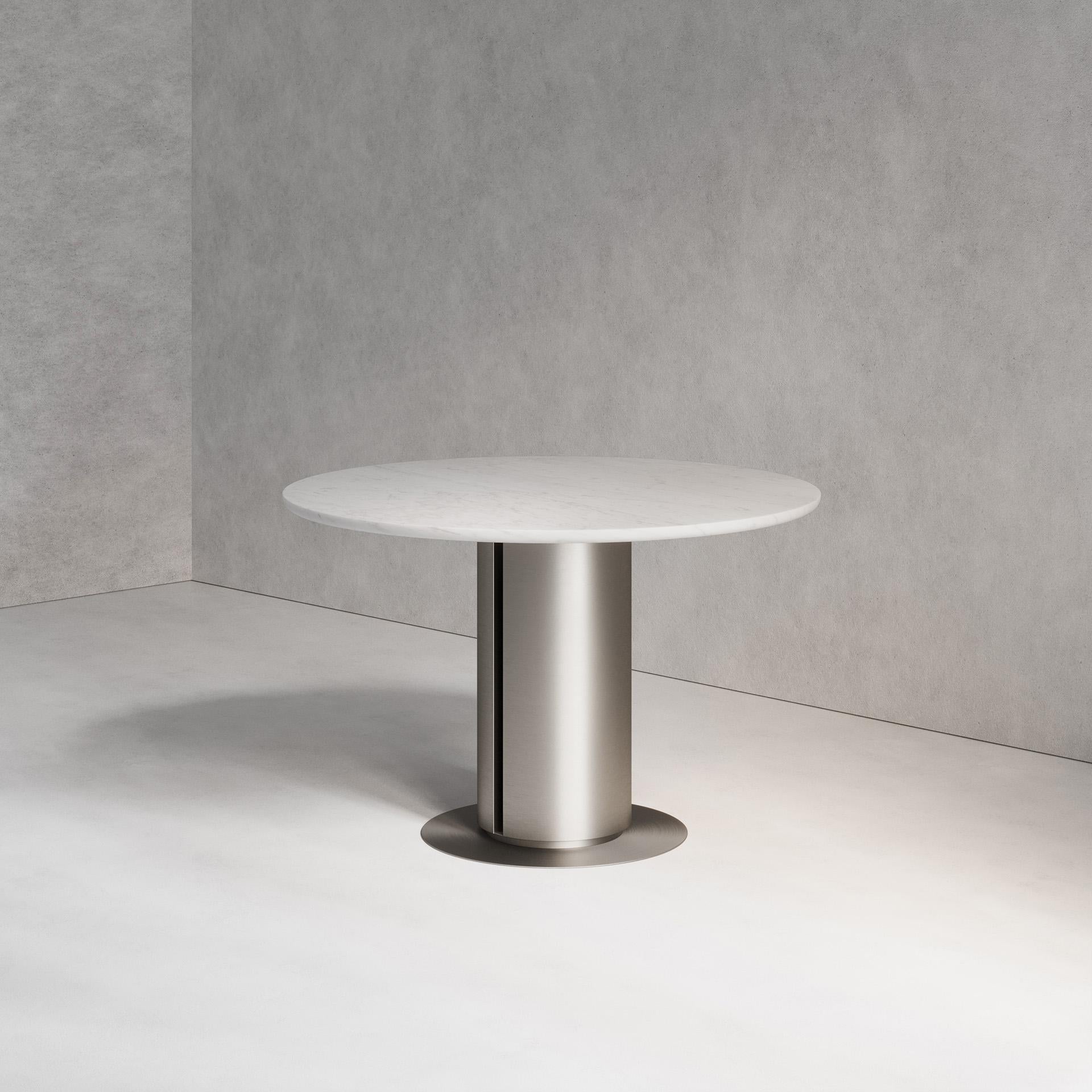 The Seleno Dining Table combines both steel and marble. Using brushed hand-spun steel and Bianco Lasa marble, this piece plays with both material properties and artisan finishes. Handmade in London.

Dimensions:
Dia. 120cm (47.24”) Height 76cm
