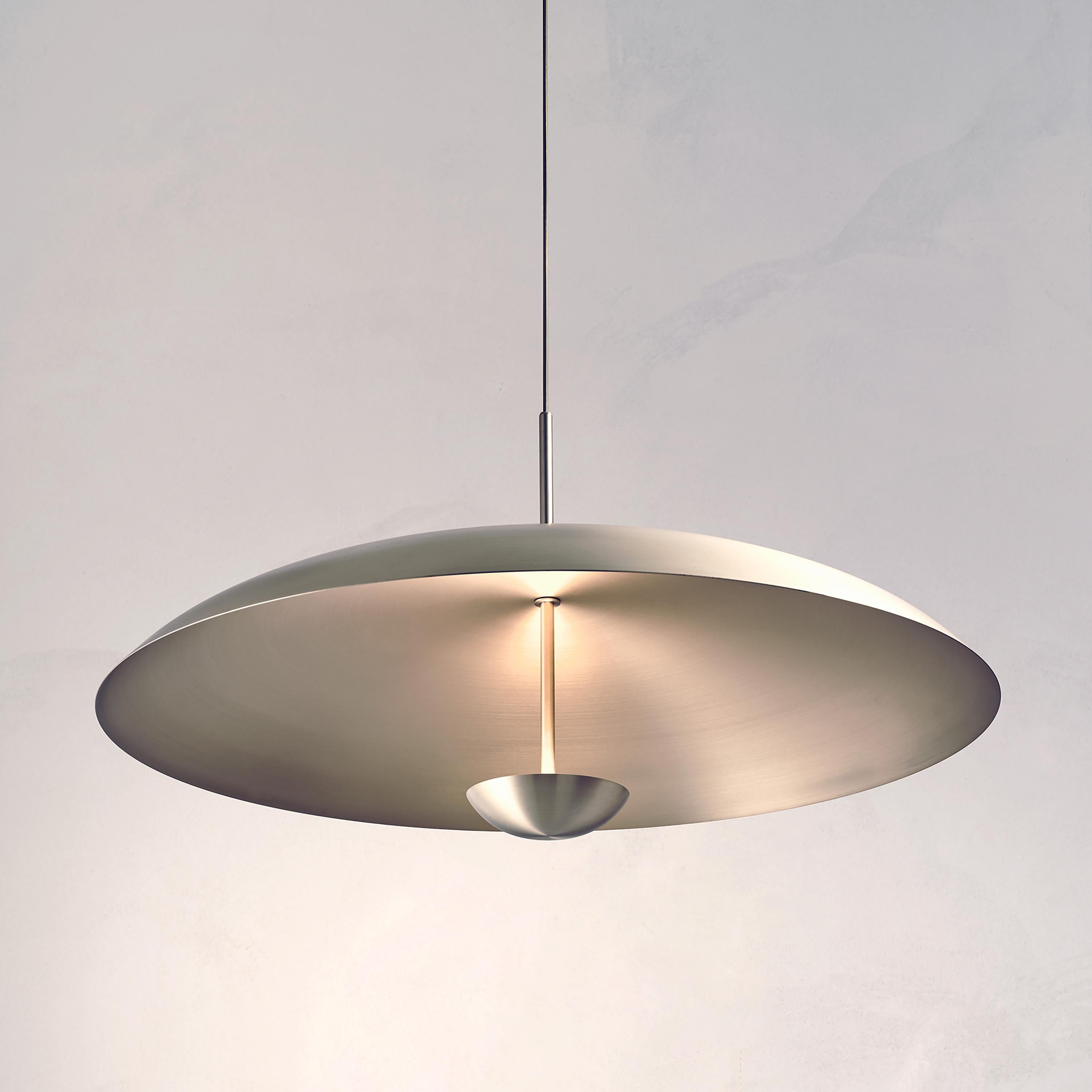 Inspired by planet-like shapes and textures, the Cosmic collection plays with both metal properties and a selection of patina finishes.
 
Composed with two carefully hand-spun steel plates, the Seleno Pendant preserves the beautiful texture and