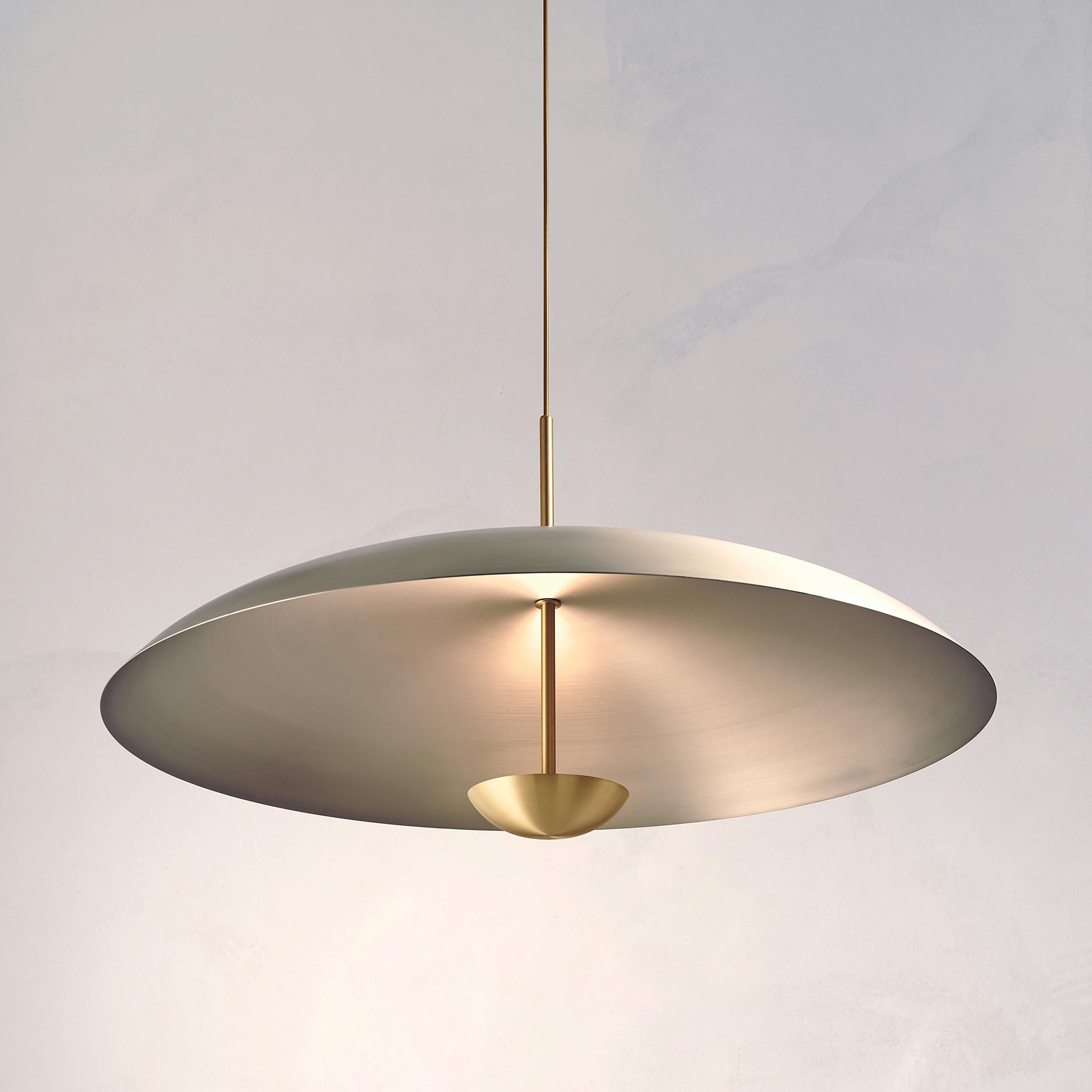 Inspired by planet-like shapes and textures, the Cosmic collection plays with both metal properties and a selection of patina finishes.
 
Composed with two carefully hand-spun plates, the Seleno Pendant preserves the beautiful texture and qualities