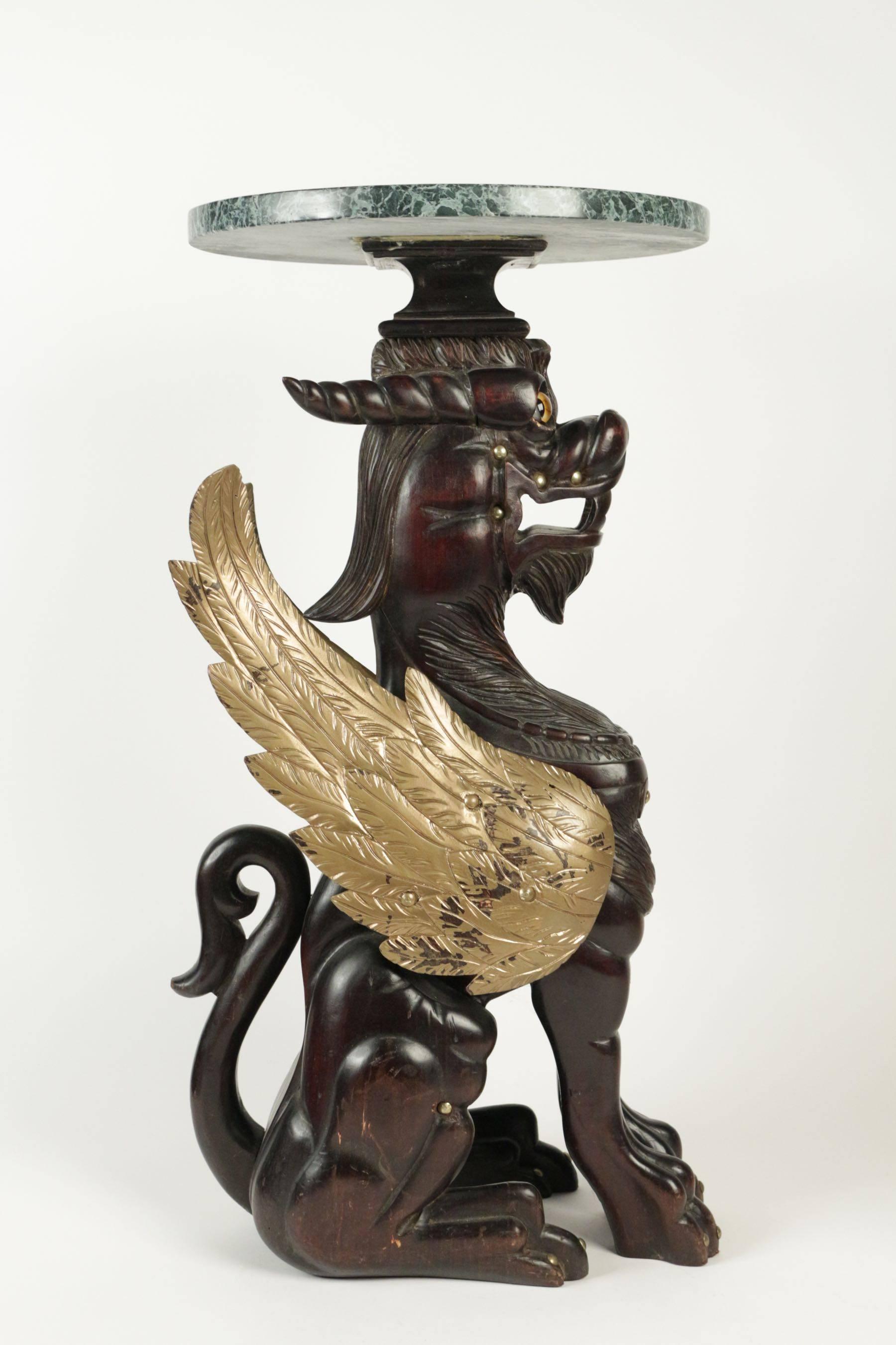 Selette in wood with a tabletop in marble representing a golden winged dragon. 20th century.
 