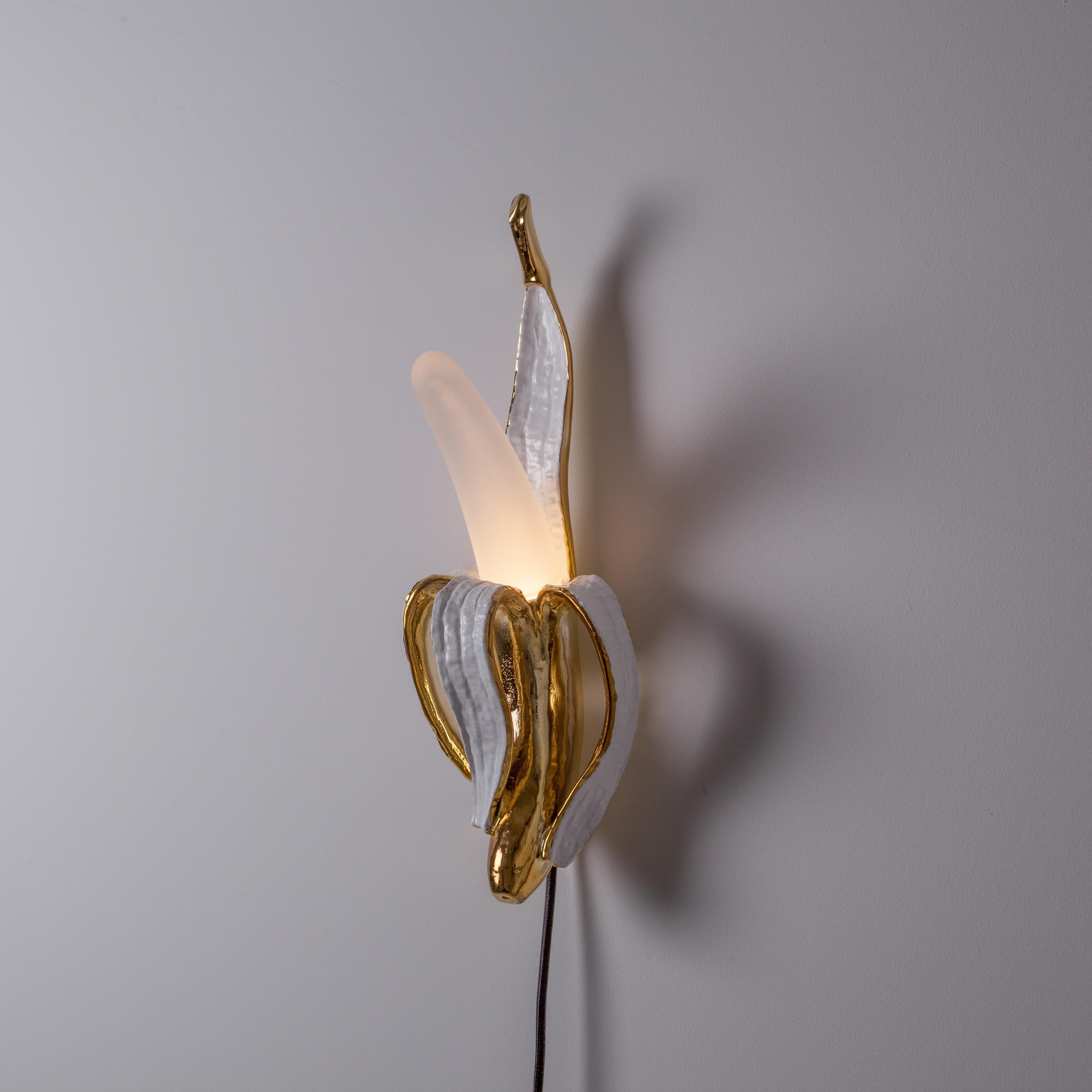 Banana Lamp by Studio Job in polished bronze is a symbol of outlandish creativity. Seletti and Unlimited edition has proposed it in four glass and resin versions: Huey, Dewey, Louie & Phooey.

- Dimmable lamp
- Material: Resin, glass
- Size: Cm