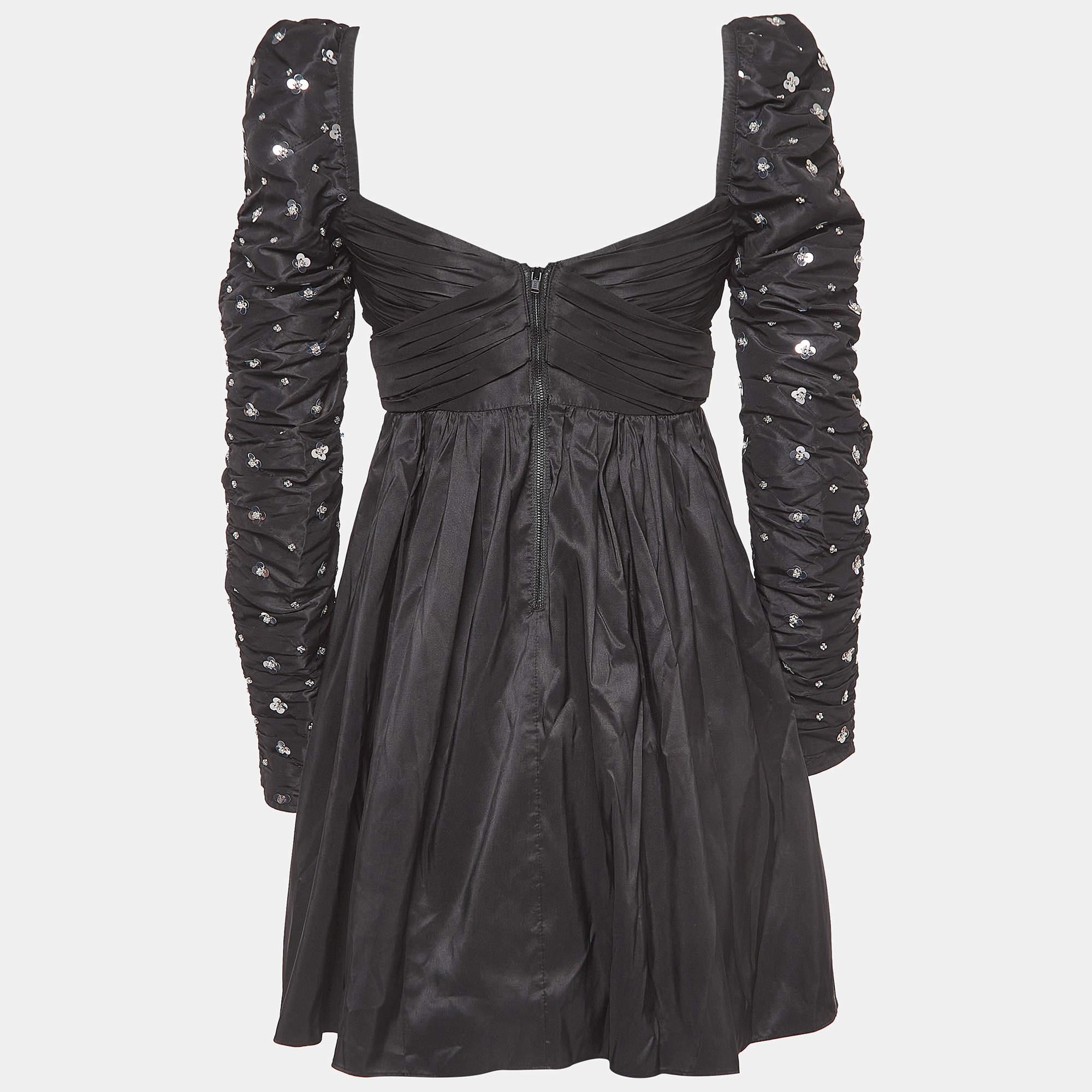Elegance takes center stage with this Self-Portrait black mini dress. Its sleek silhouette is adorned with intricate clusters of sequins, creating a mesmerizing play of light and shadow. Perfect for those who appreciate sophistication with a touch