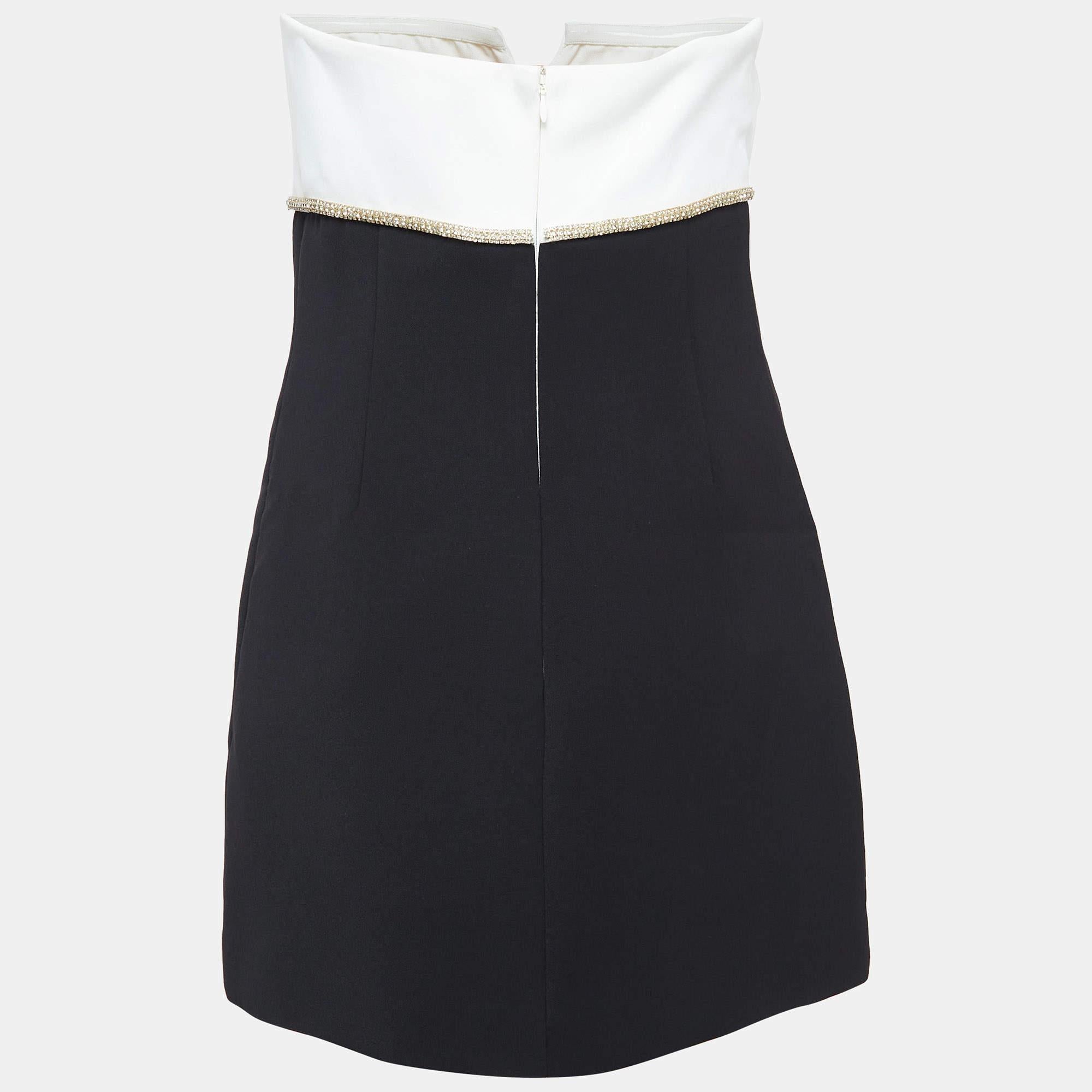 This strapless Self Portrait mini dress features a striking black and white color palette accentuated by a delicate crepe bow detail. The structured silhouette and bold design make it a standout choice for any event. Ideal for making a stylish