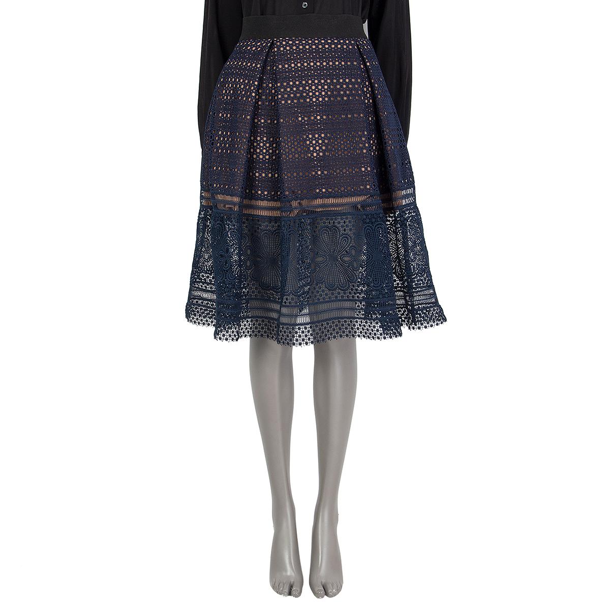 100% authentic Self-Portrait crochet skirt in midnight blue polyester (98%) and cotton (2%) with pockets. Has a black elastic waist. Closes on the back with a zipper. Lined in nude polyester (95%) and spandex (5%). Has been worn and is in excellent
