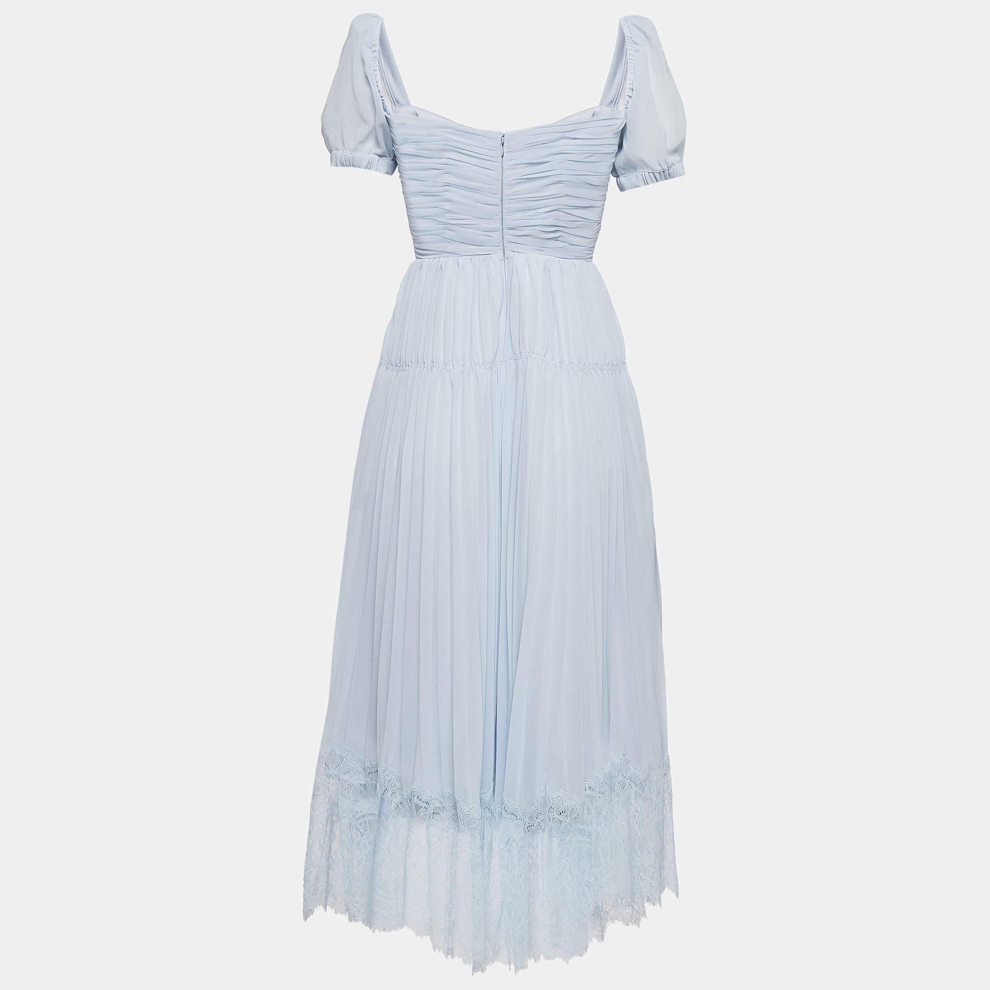 This Self-Portrait dress exudes elegance with its light blue hue and pleated chiffon fabric. The midi length adds sophistication while the cut-out details offer a hint of allure. Perfect for a romantic evening or a special occasion, it effortlessly