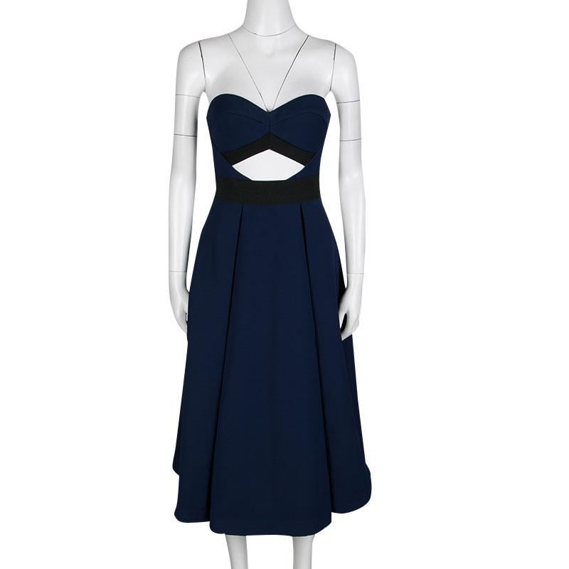 Cast an elegant style statement with this Lulu dress from Self Portrait's Spring 2016 collection. Flaunting an understated navy blue hue, the dress is characterized by the cutouts that flatter the waist and back of the strapless bodice. The bottom