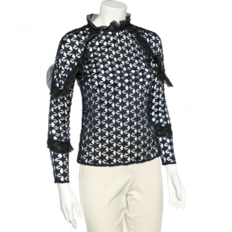 Overlaid delicately into a fine silhouette, this top from Self-Portrait brings out true charm and beauty in every woman! It is fashioned in navy-blue star lace fabric, embellished with ruffled formations. It has long sleeves and a zip fastening at