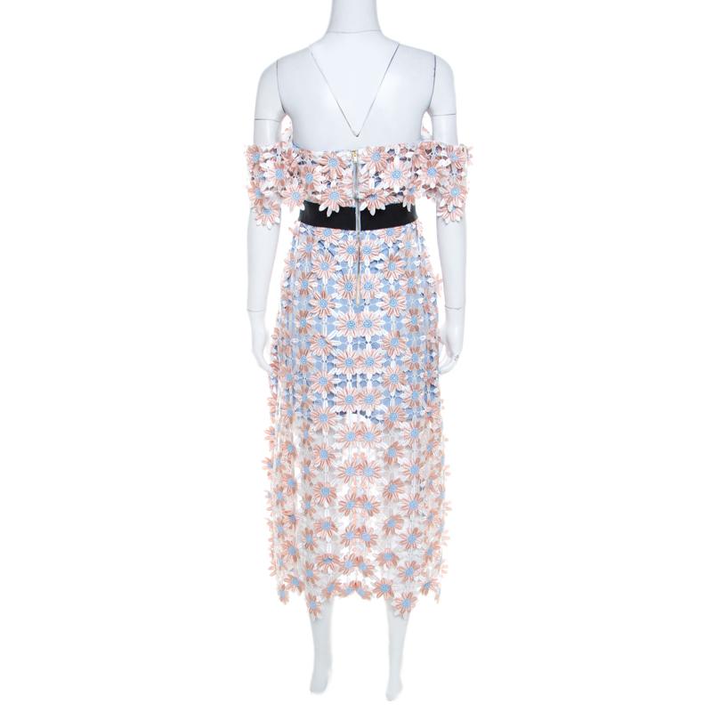 From the house of Self Portrait, this dress is a masterpiece creation. A pink dress like this will remain a classic masterpiece in your wardrobe. Finely designed with floral appliques all over, this dress is tailored in a midi silhouette with an