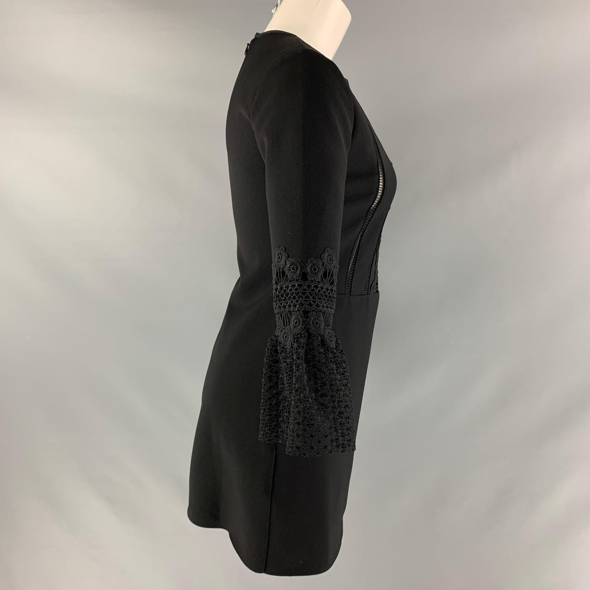 SELF-PORTRAIT dress comes in a black polyester fabric featuring an a-line style, see through panel, long sleeves, and an invisible zip up closure at center back. Excellent Pre-Owned Condition. 

Marked:   4 

Measurements: 
 
Shoulder: 14.5 inches