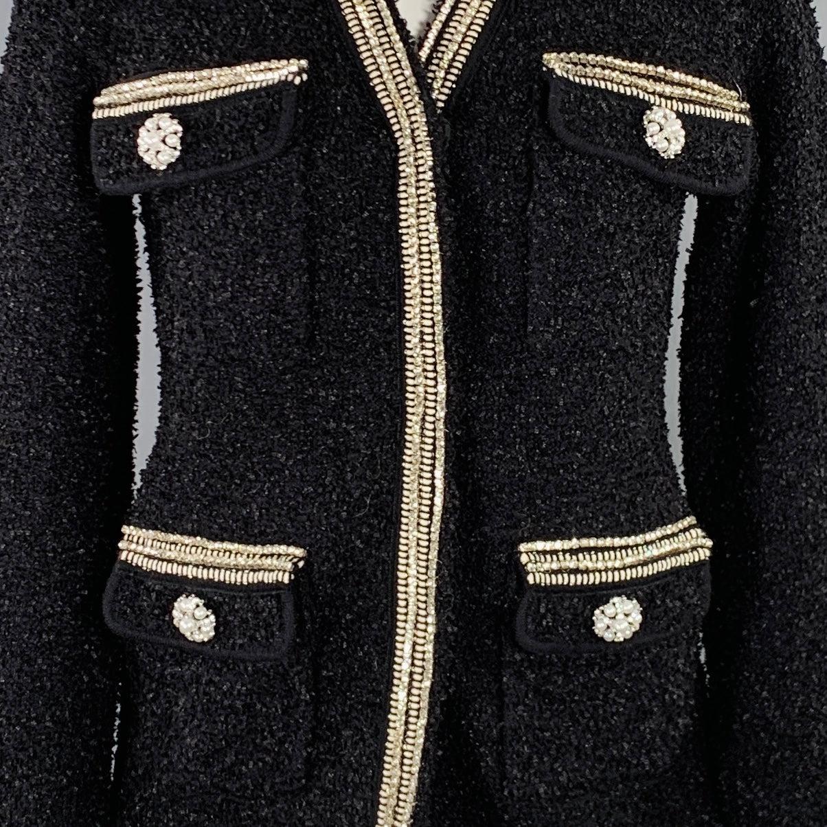 SELF-PORTRAIT cardigan
in a black polyamide blend knit featuring rhinestone trim, faux pearl and rhinestone button details, and hidden snap closure. Excellent Pre-Owned Condition. 

Marked:   S 

Measurements: 
 
Shoulder: 17 inches Bust: 36 inches