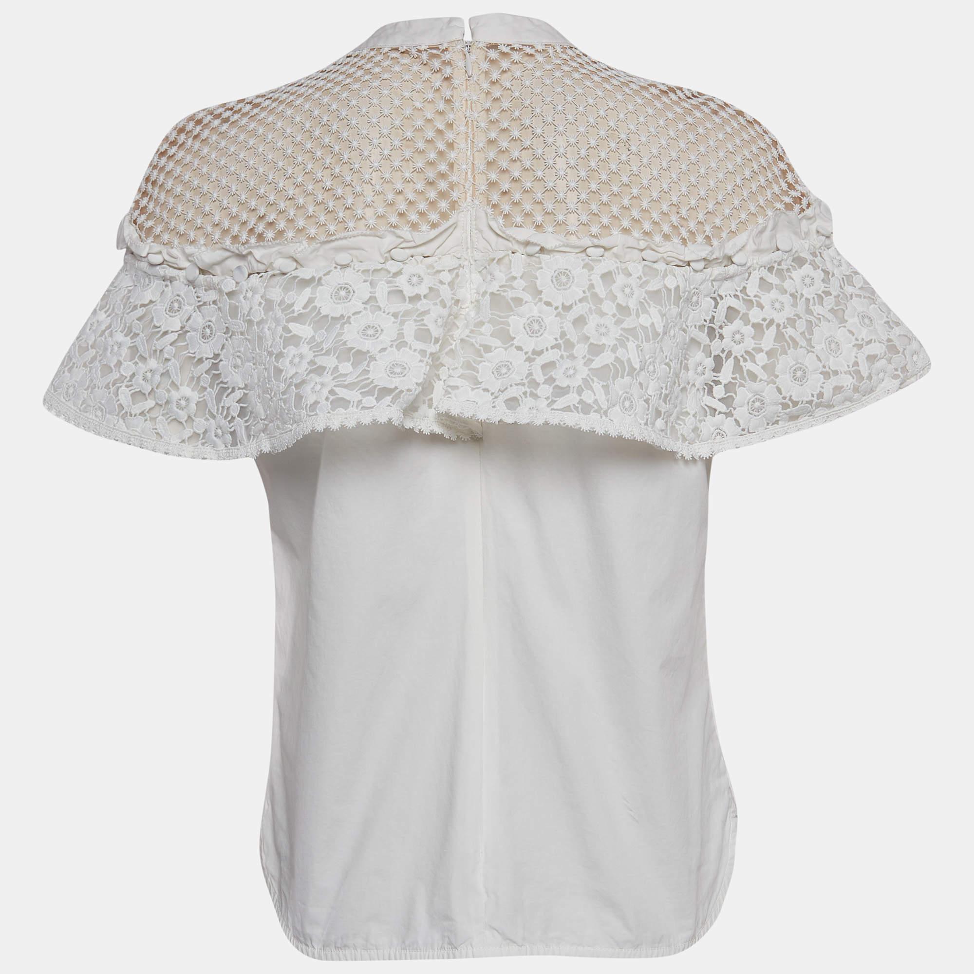 Crafted with exquisite detail the Self Portrait top epitomizes elegance. Delicate lacework intertwines to form a captivating pattern exuding sophistication. Paired with a tonal trouser it creates a harmonious blend of textures resulting in a