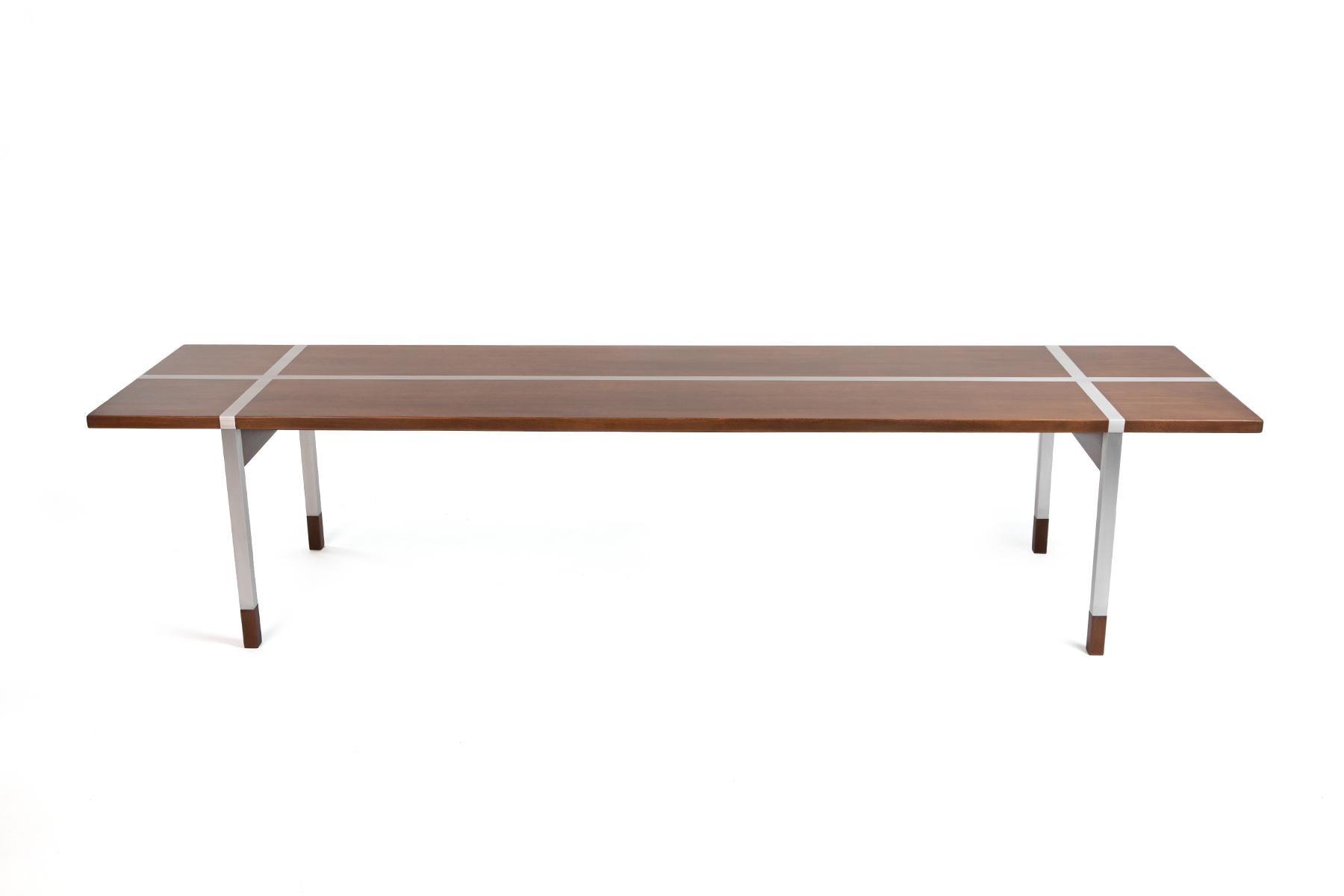Striking walnut and aluminum coffee table by Selig circa early 1950s. Table has been newly polished and refinished.